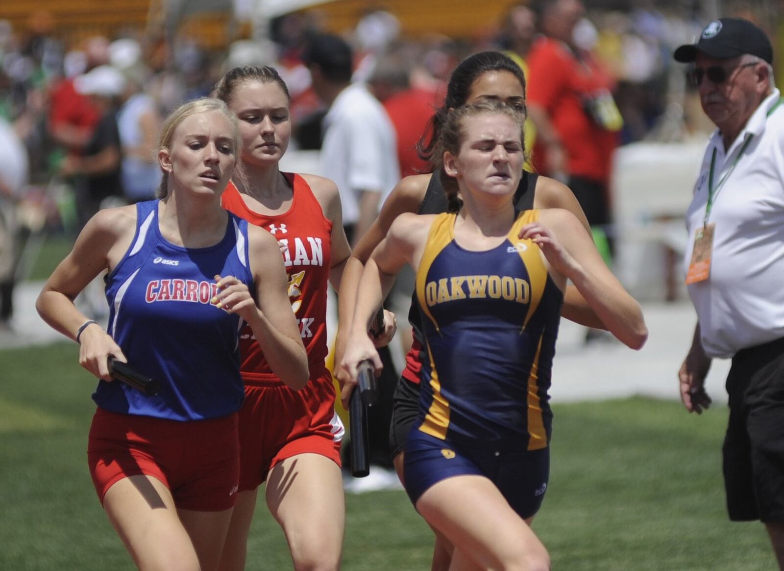 Oakwood’s Elizabeth Vaughn (right) passes a Carroll runner in the 3,200 relay during the D-II state track and field meet at OSU’s Jesse Owens Memorial Stadium in Columbus on Friday, May 31, 2019. MARC PENDLETON / STAFF