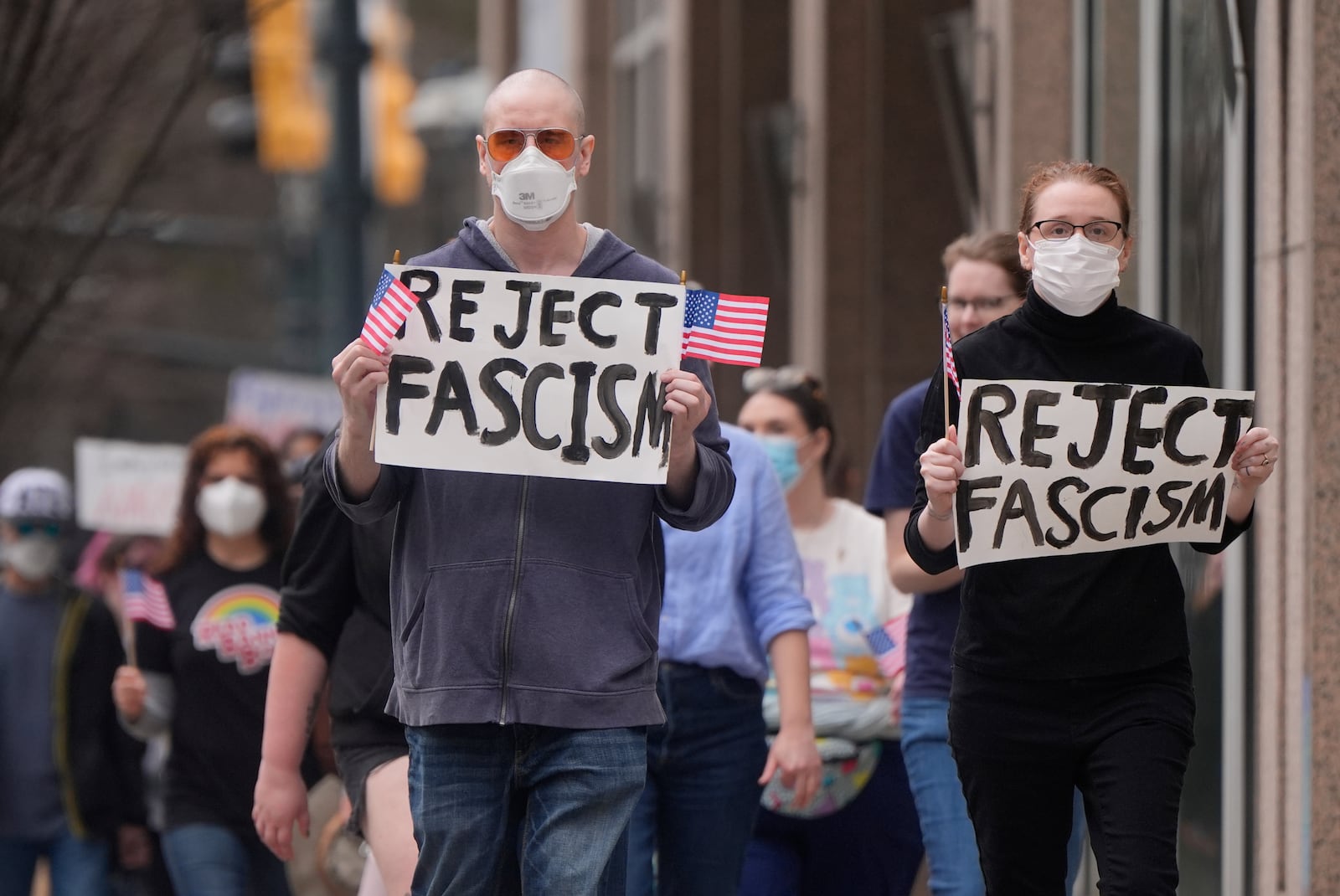 Demonstrators march toward state capital Wednesday, Feb. 5, 2025, in downtown Atlanta. (AP Photo/Mike Stewart)