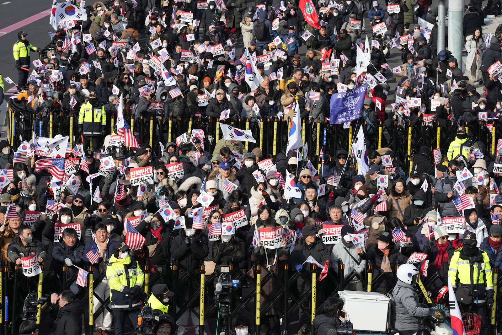 Supporters of impeached South Korean President Yoon Suk Yeol stage a rally to oppose a court having issued a warrant to detain Yoon, near the presidential residence in Seoul, South Korea, Friday, Jan. 3, 2025. The letters read, "Oppose Impeachment." (AP Photo/Lee Jin-man)