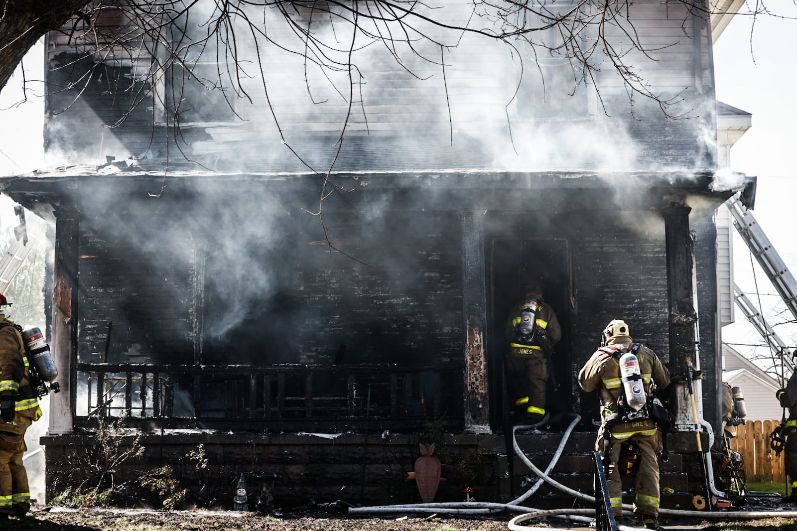 Windy conditions posed challenges for Dayton firefighters at the scene of a house fire Wednesday afternoon, March 20, 2024, in the 1100 block of Carlisle Avenue. JIM NOELKER/STAFF