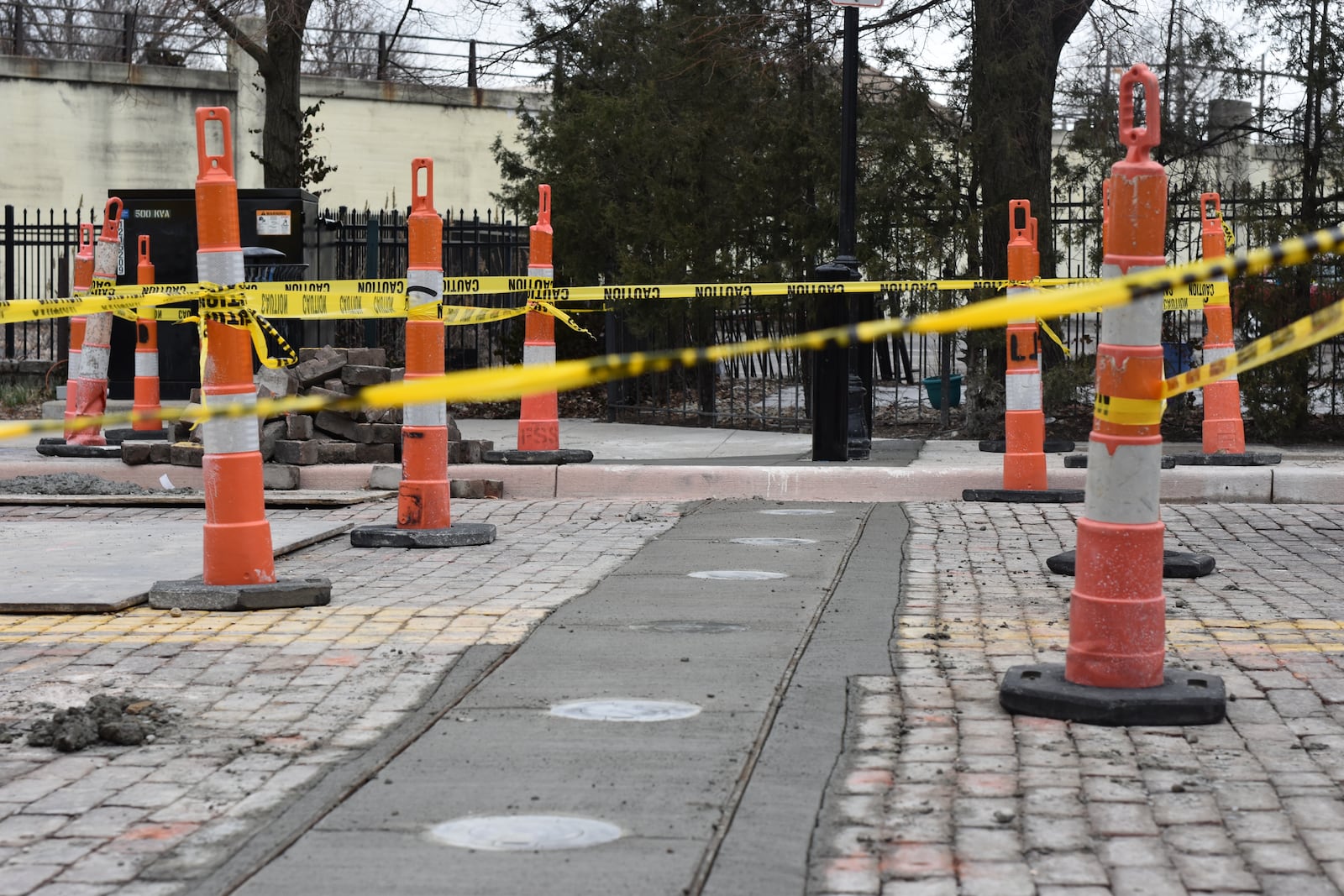 City of Dayton is installing bollards on East Fifth Street and side streets in the Oregon District, which will help shut the streets down to vehicular traffic during Out on 5th and similar kinds of events. CORNELIUS FROLIK / STAFF