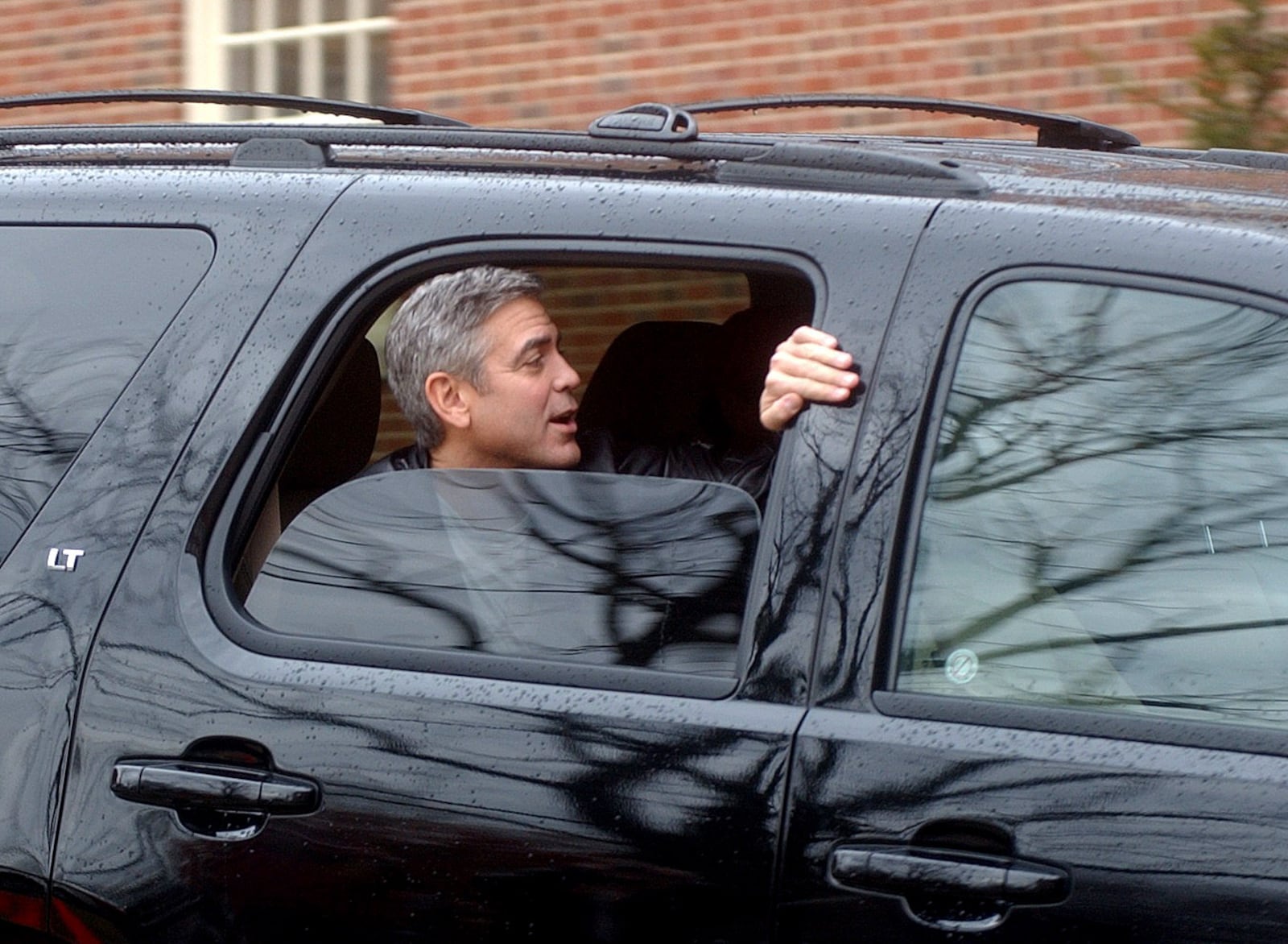 George Clooney leaves out the back of Hall Auditorium after wrapping filming in Oxford on his film "The Ides of March" Friday, March 4. Staff photo by Meagan Engle