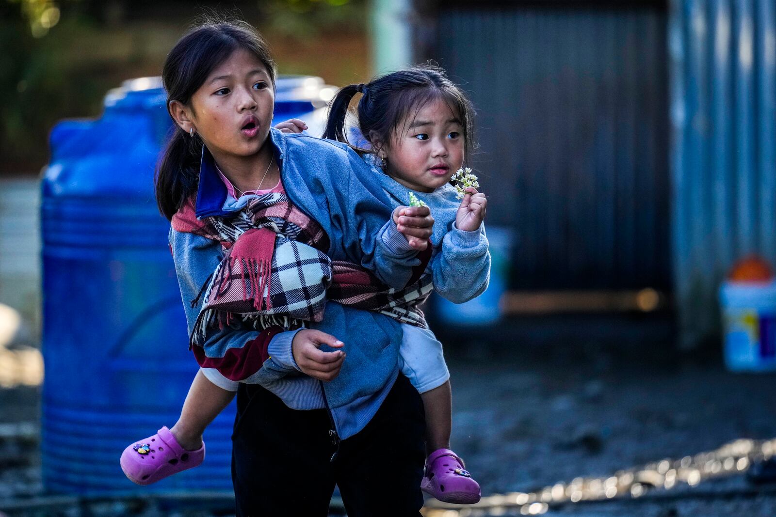 Kuki tribal children play outside their relief camp in Kangpokpi, Manipur, Sunday, Dec. 15, 2024. (AP Photo/Anupam Nath)