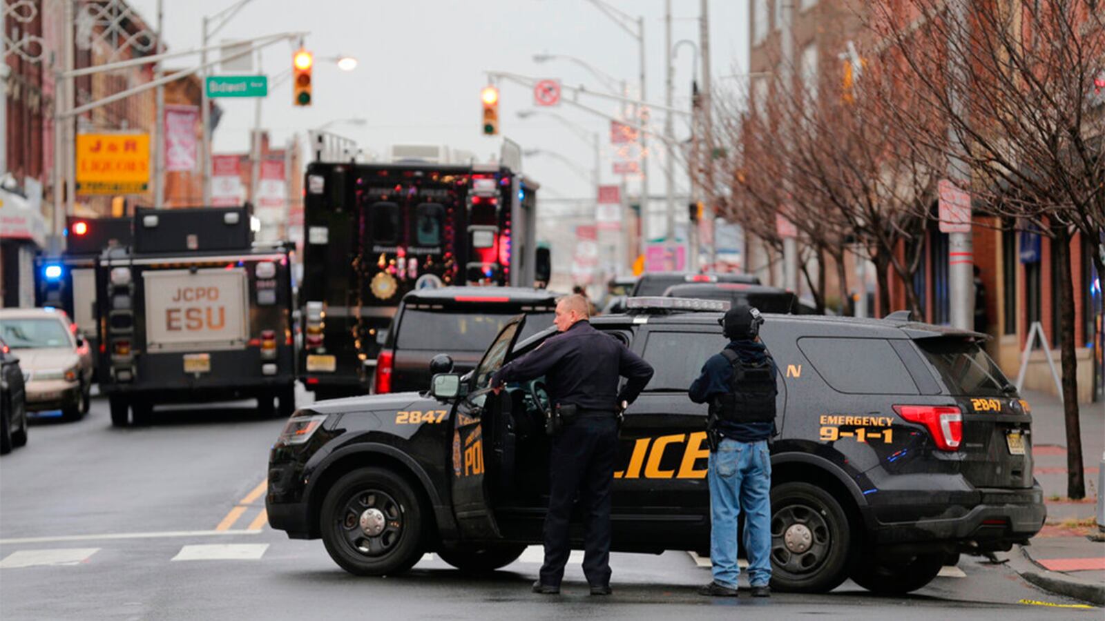 Jersey City Police officers man a road block following reports of gunfire, Tuesday, Dec. 10, 2019, in Jersey City, N.J.  (AP Photo/Seth Wenig)