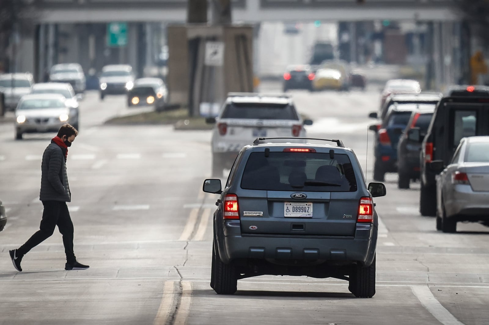 Pedestrians make their way across Main Street in Downtown Dayton. 
JIM NOELKER/STAFF