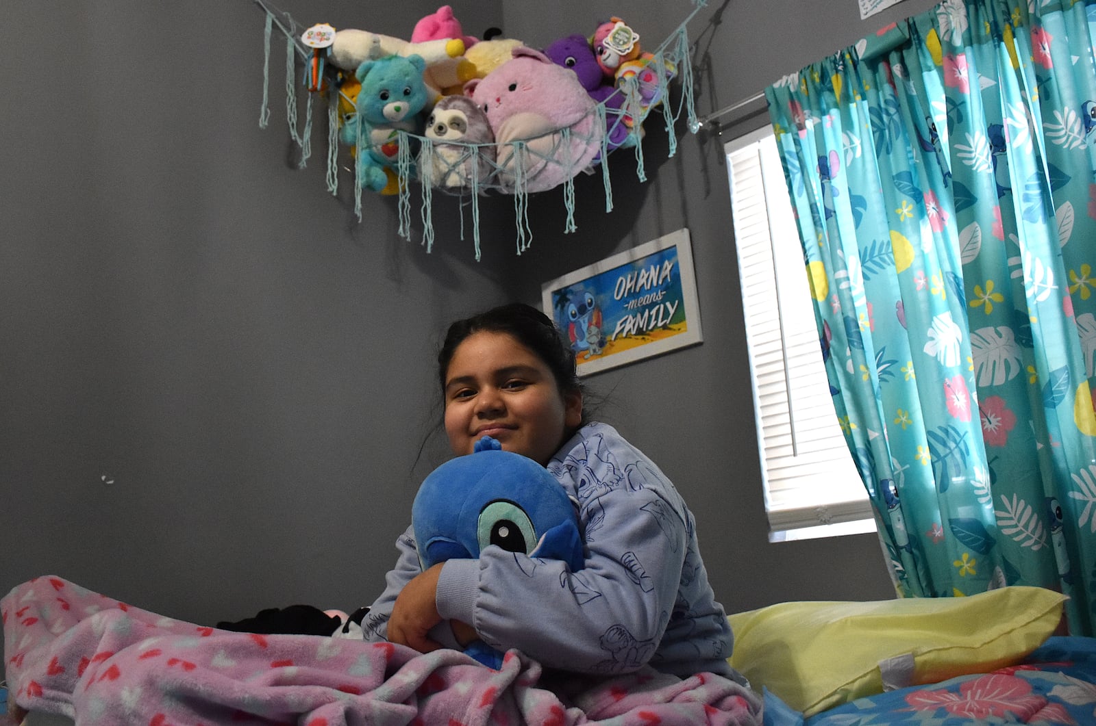 Ashley Escalante, 9, in bed at her East Dayton home on Dec. 18, 2024. Ashley's left foot was amputated after a hit-and-run crash on Wayne Avenue in Dayton on July 22, 2024. Ashley was in the hospital for about 50 days. CORNELIUS FROLIK / STAFF