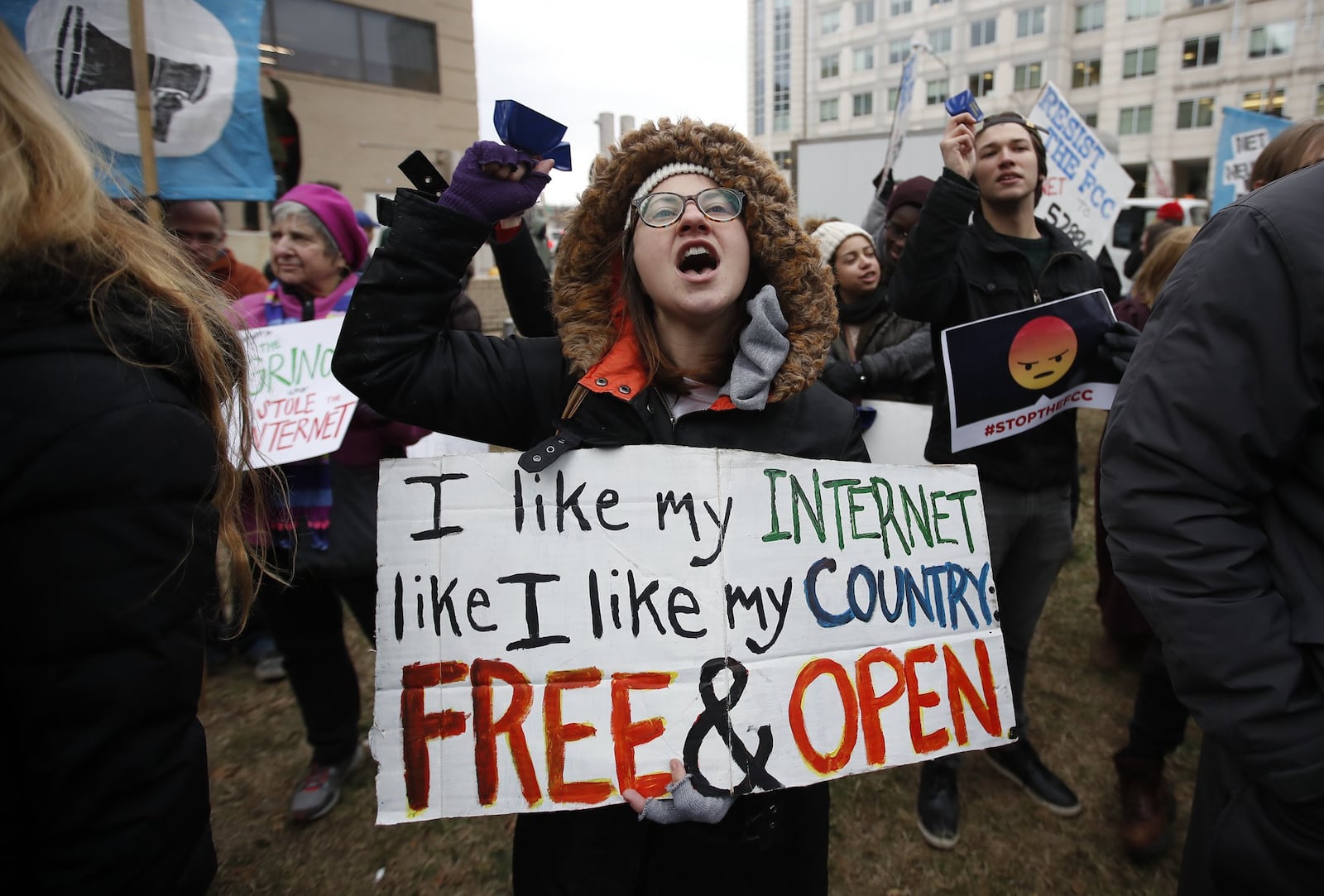 Lindsay Chestnut of Baltimore holds a sign that reads “I like My Internet Like I Like my Country Free & Open” as she protests near the Federal Communications Commission (FCC), in Washington, Thursday, Dec. 14, 2017. (AP Photo/Carolyn Kaster)