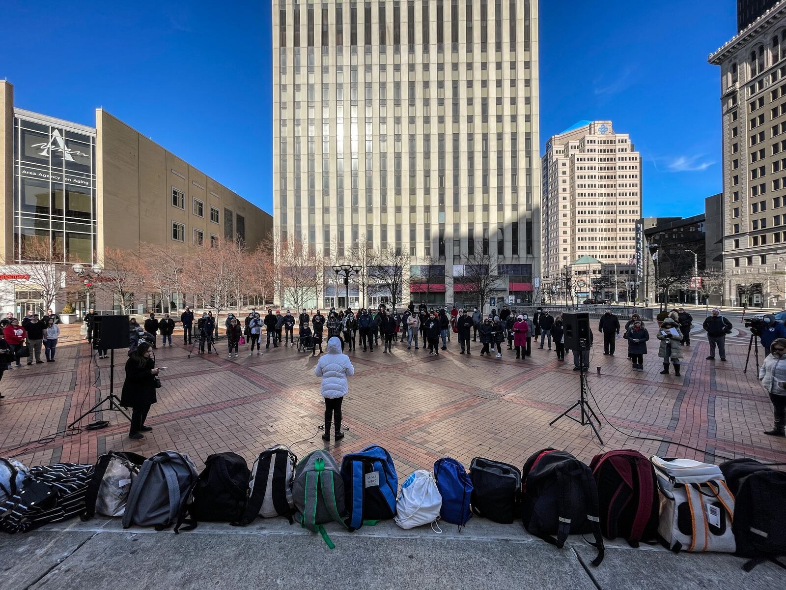 Backpacks filled with items for Dayton's homeless population line the stage at Courthouse Square. The memorial for the homeless in Montgomery County was held Tuesday Dec. 21, 2021. JIM Noelker/STAFF