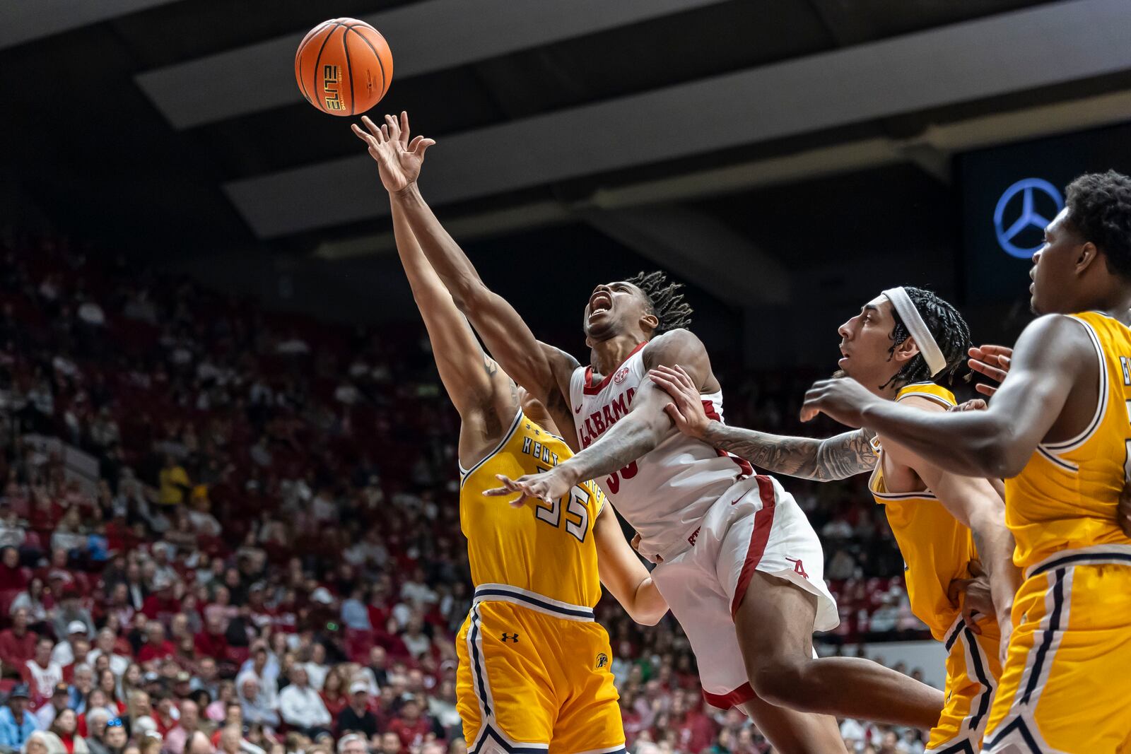 Alabama forward Derrion Reid (35) shoots past Kent State forward Donovan Hunter (55) during the first half of an NCAA college basketball game, Sunday, Dec. 22, 2024, in Tuscaloosa, Ala. (AP Photo/Vasha Hunt)