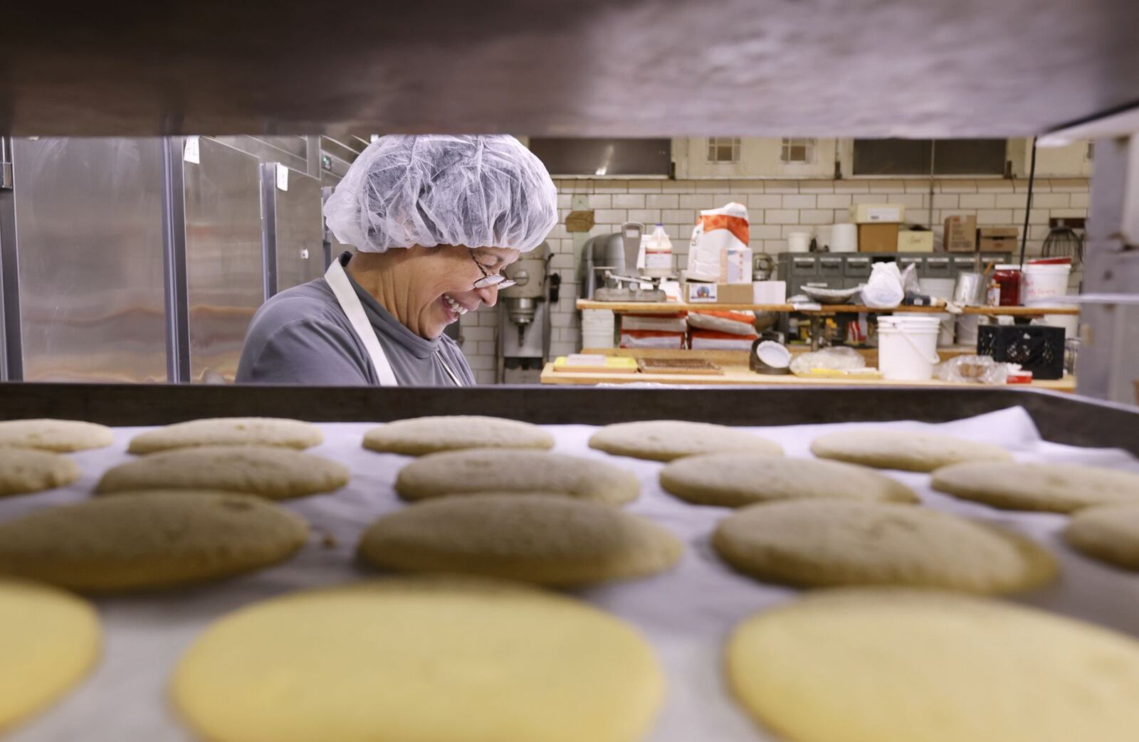 Vera Slamka smiles as she does what she loves in the kitchen at Central Pastry Tuesday, Aug. 13, 2024 on Central Avenue in Middletown. Vera and her husband, John, are celebrating owning Central Pastry for 40 years. NICK GRAHAM/STAFF