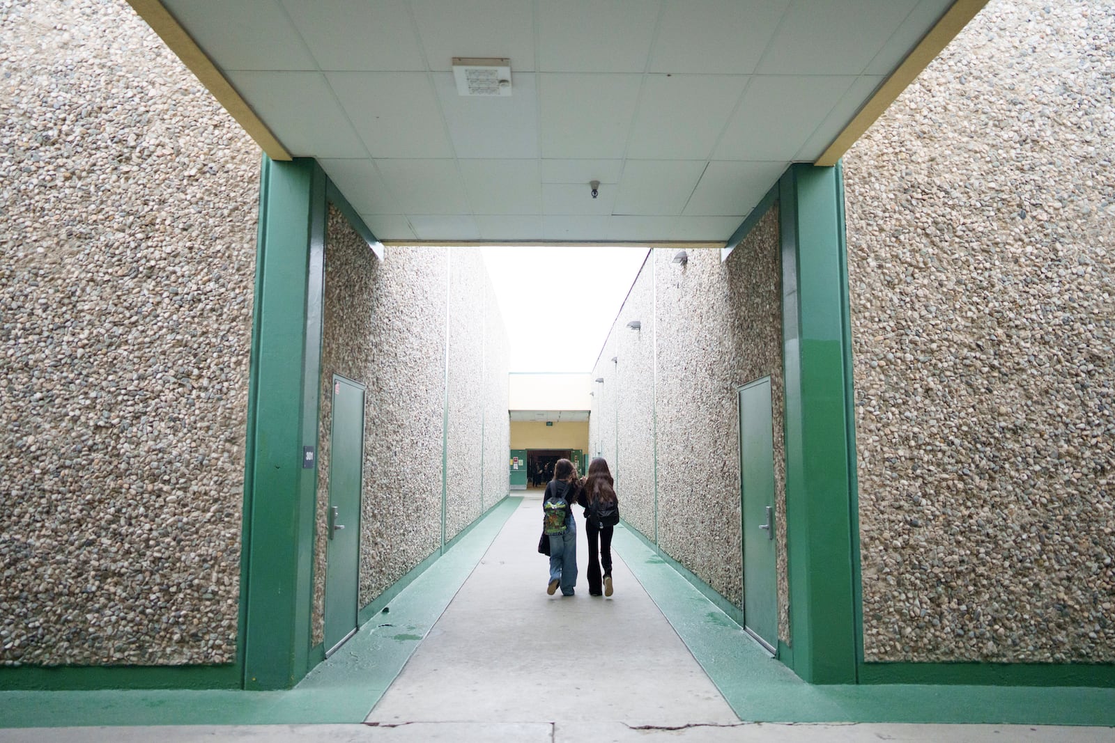 Students walk through a hallway at Benjamin O. Davis Middle School in Compton, Calif., Thursday, Feb. 6,, 2025. (AP Photo/Eric Thayer)