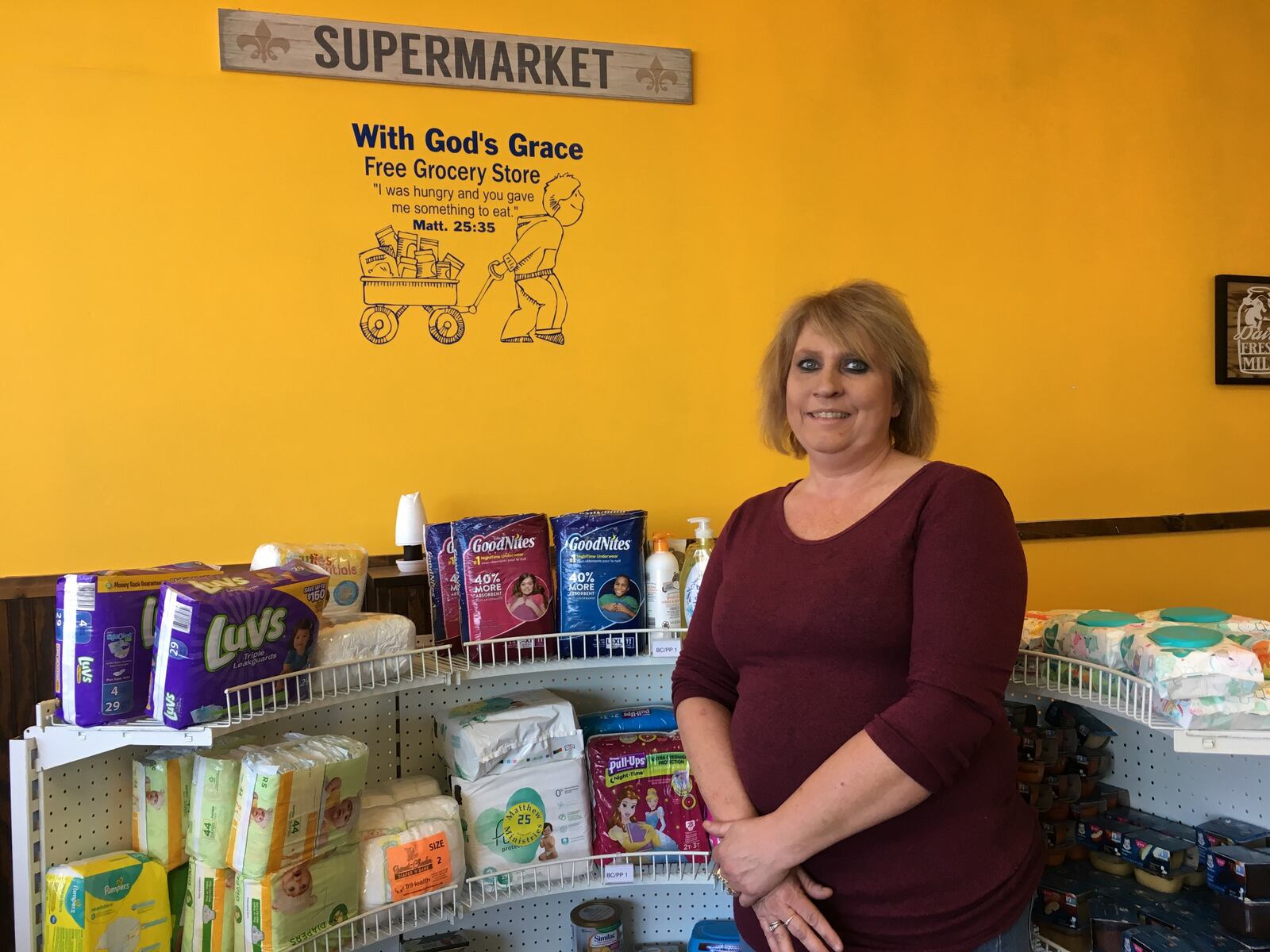 Nicole Adkins, With God's Grace executive director, stands inside the non-profit's new free grocery store at 5505 North Dixie Dr. in Dayton.