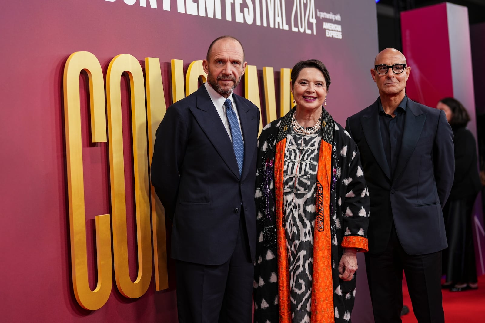 Ralph Fiennes, from left, Isabella Rossellini and Stanley Tucci, pose for photographers upon arrival at the premiere of the film 'Conclave' during the London Film Festival on Thursday, Oct. 10, 2024, in London. (Photo by Scott A Garfitt/Invision/AP)