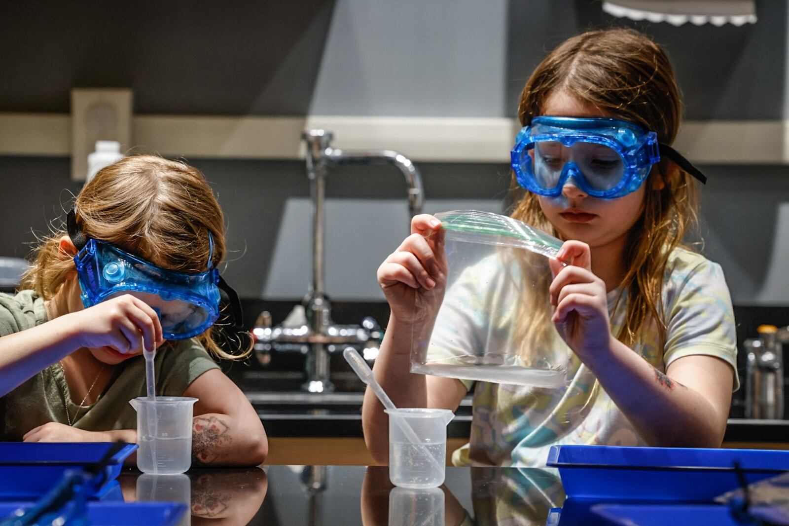 Paislee and Madilyn Daniels from Sydney create a calcium chloride reaction in the Do Lab at Boonshoft Museum of Discovery Tuesday January 23, 2024. JIM NOELKER/STAFF