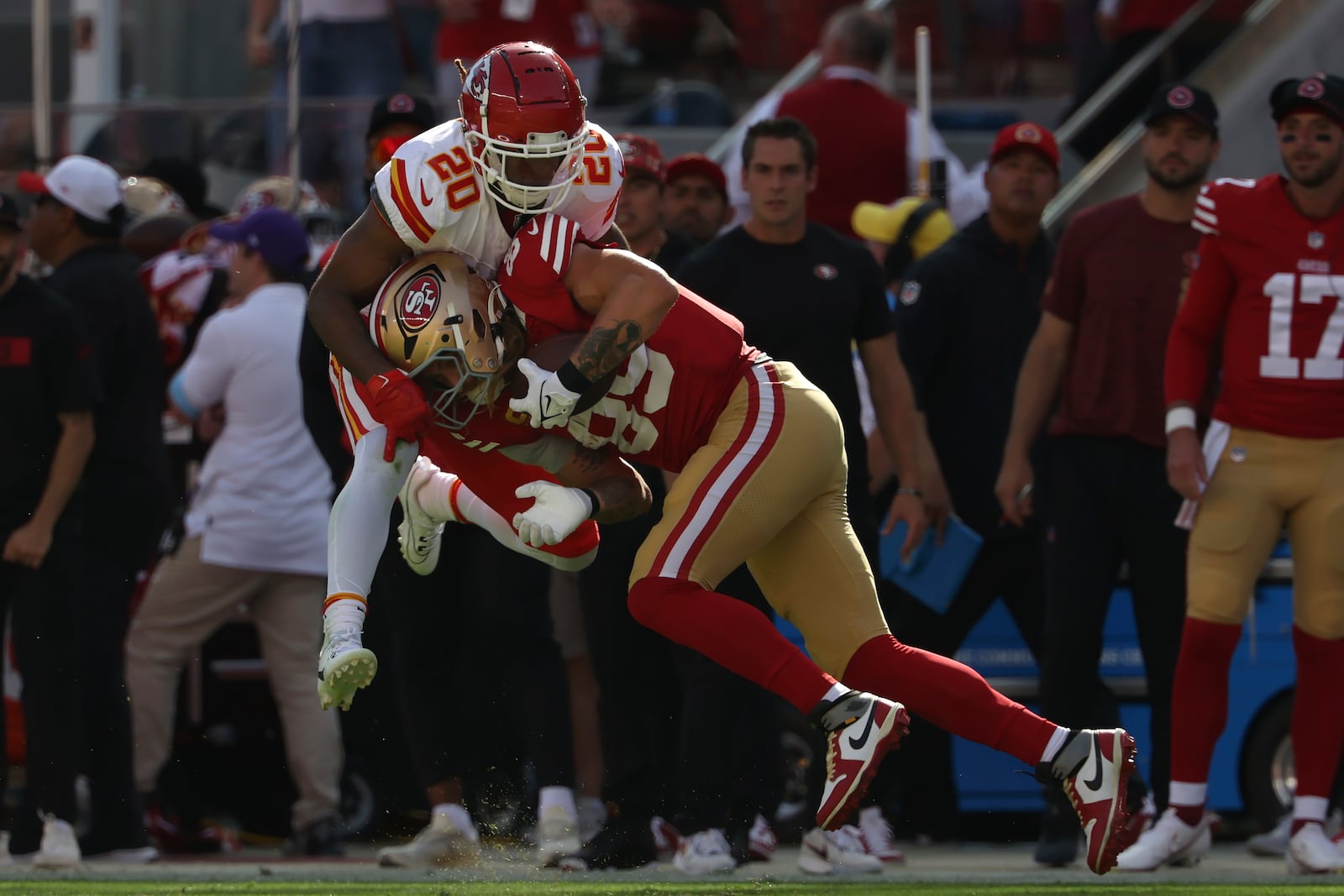 San Francisco 49ers tight end George Kittle, bottom, catches a pass against Kansas City Chiefs safety Justin Reid during the first half of an NFL football game in Santa Clara, Calif., Sunday, Oct. 20, 2024. (AP Photo/Jed Jacobsohn)