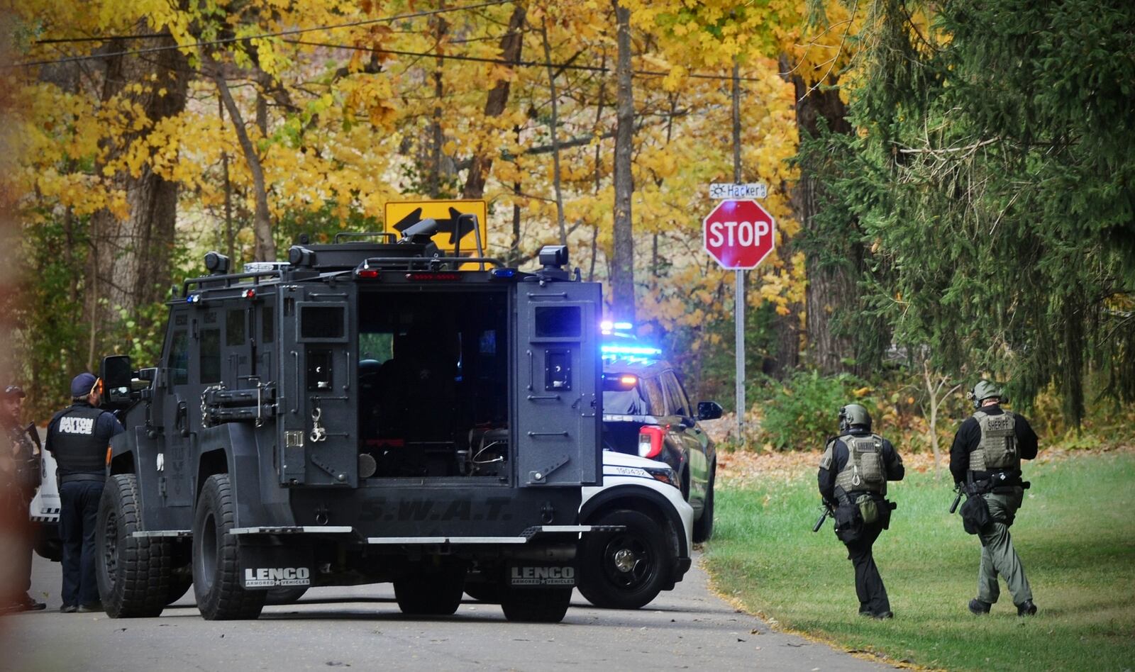 Dayton, police and swat team Montgomery county sheriffs around the house on Hacker Road after an officer was shot while serving a warrant Thursday afternoon. MARSHALL GORBY \STAFF