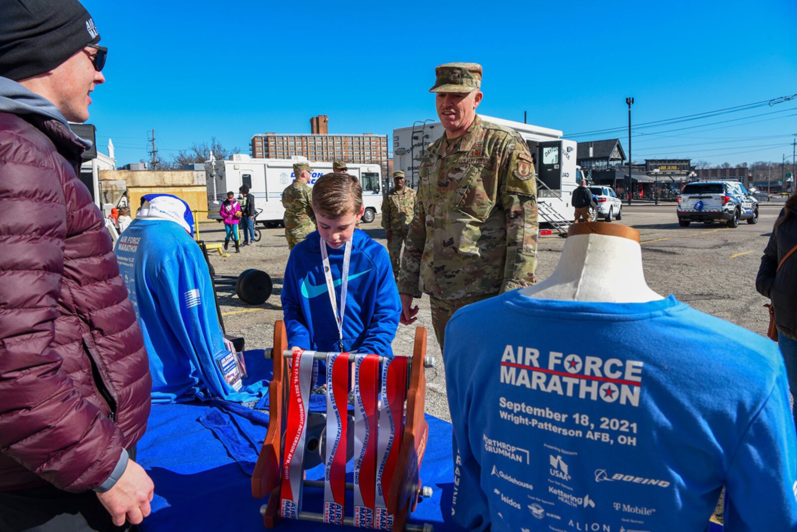 Chief Master Sgt. Jason Shaffer, 88th Air Base Wing command chief, visits the Air Force Marathon table at the Big Hoopla Family Festival in the Oregon District on March 13. U.S. AIR FORCE PHOTO/SENIOR AIRMAN ALEXANDRIA FULTON