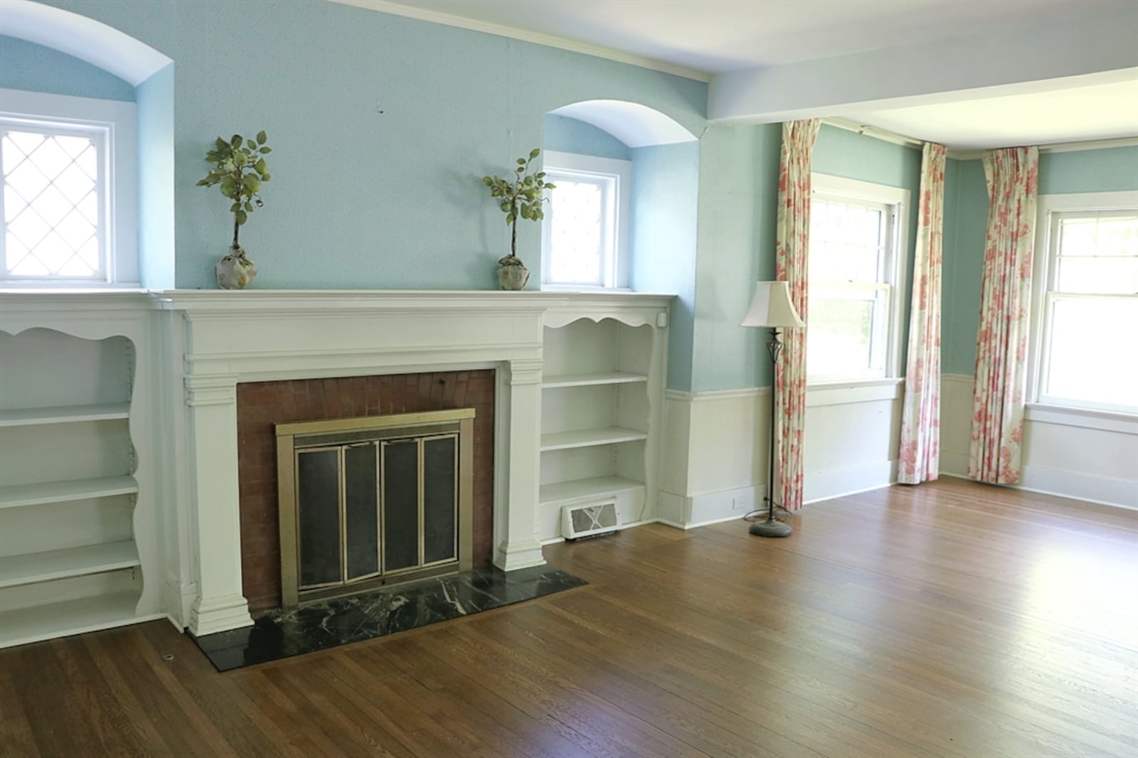 This fireplace is flanked by bookcases and window nooks. 