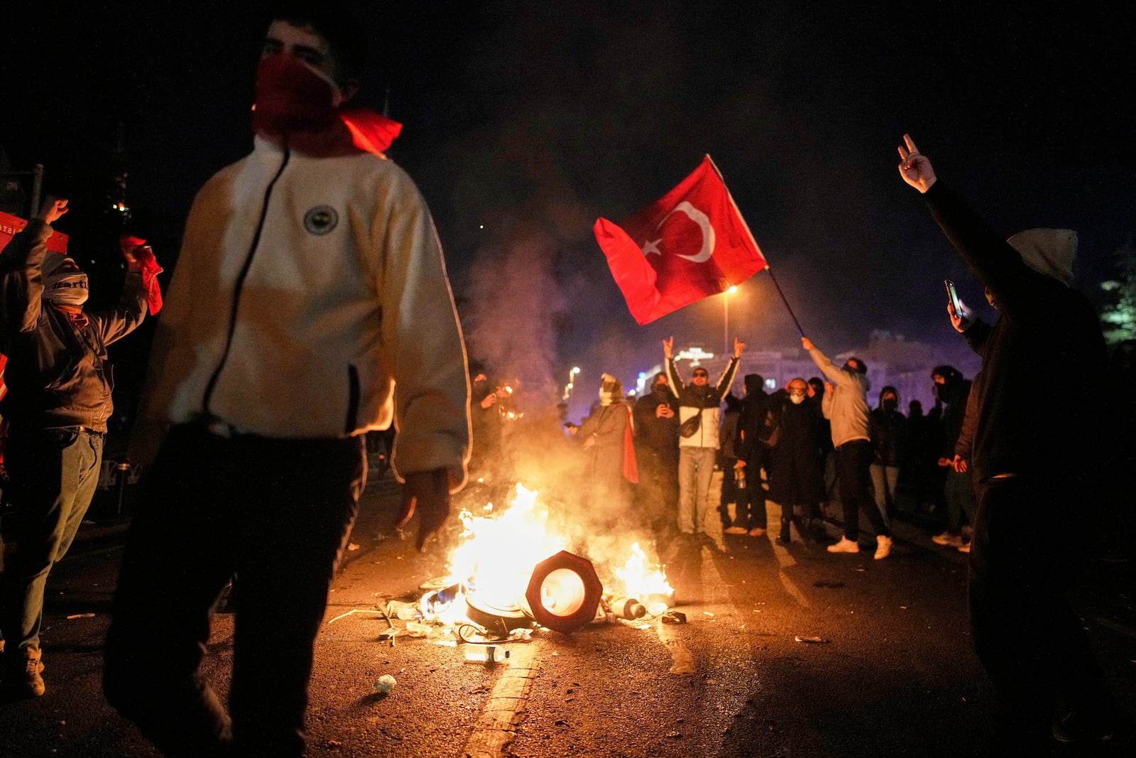 Protesters shout slogans during clashes with anti riot police during a protest against the arrest of Istanbul's Mayor Ekrem Imamoglu in Istanbul, Turkey, Friday, March 21, 2025. (AP Photo/Emrah Gurel)