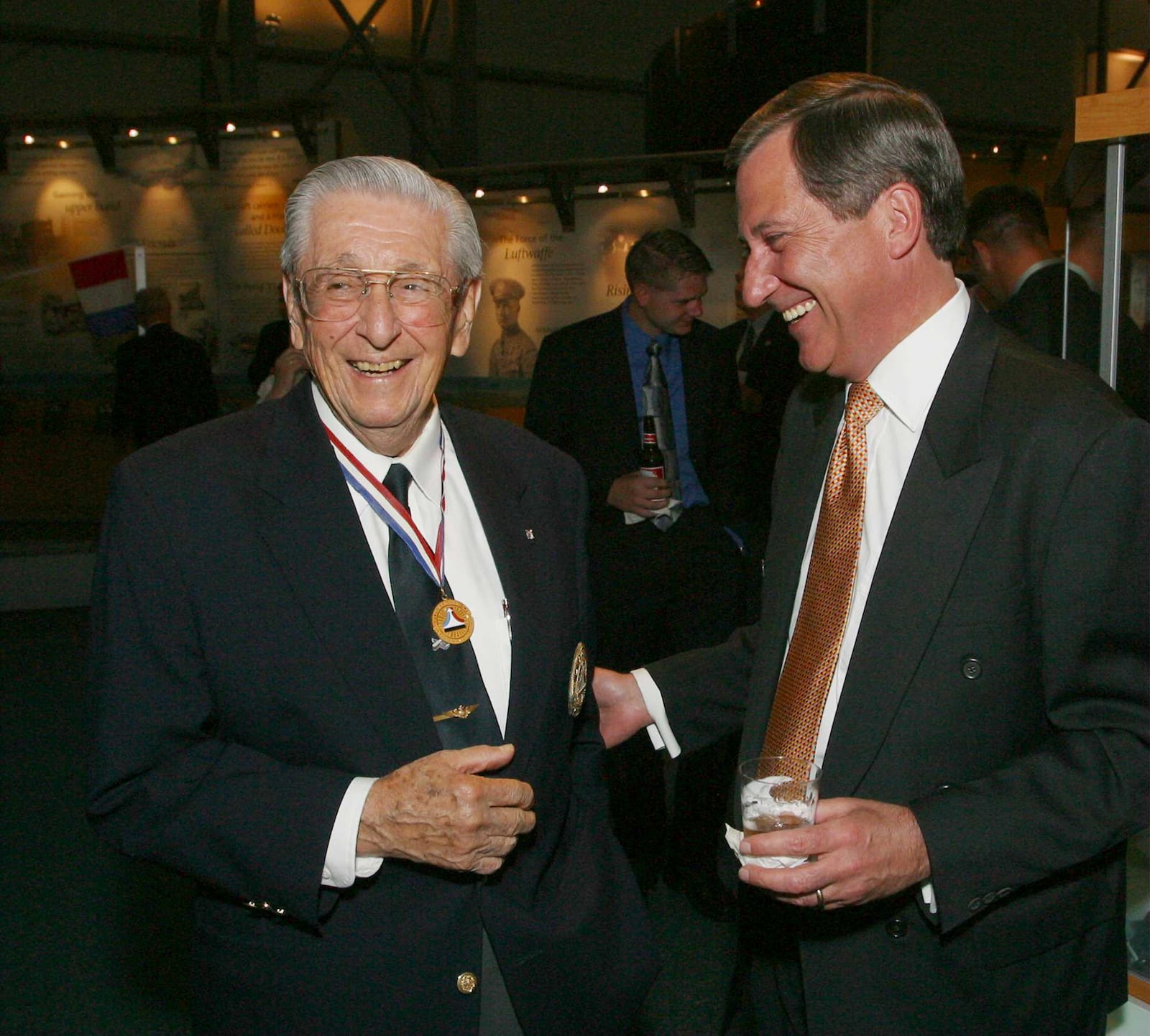 7-18-03  --  National Aviation Hall of Fame enshrinee Scott Crossfield shared a laugh with National Association of State Aviation Officials president Henry Ogrodzinski at the NAHF President's Reception and Dinner on Friday night.