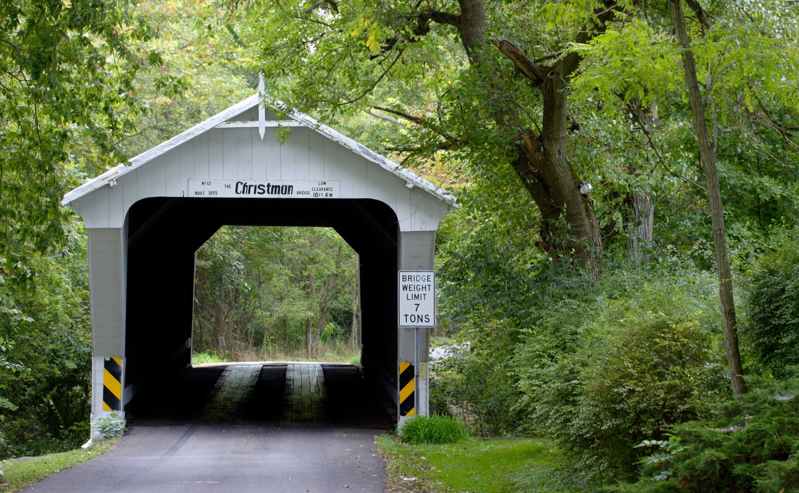 File photo, 2005. The Christman covered bridge sits in a lovely setting close to Eaton. It's one of seven covered bridges in Preble County. STAFF PHOTO BY BILL REINKE.