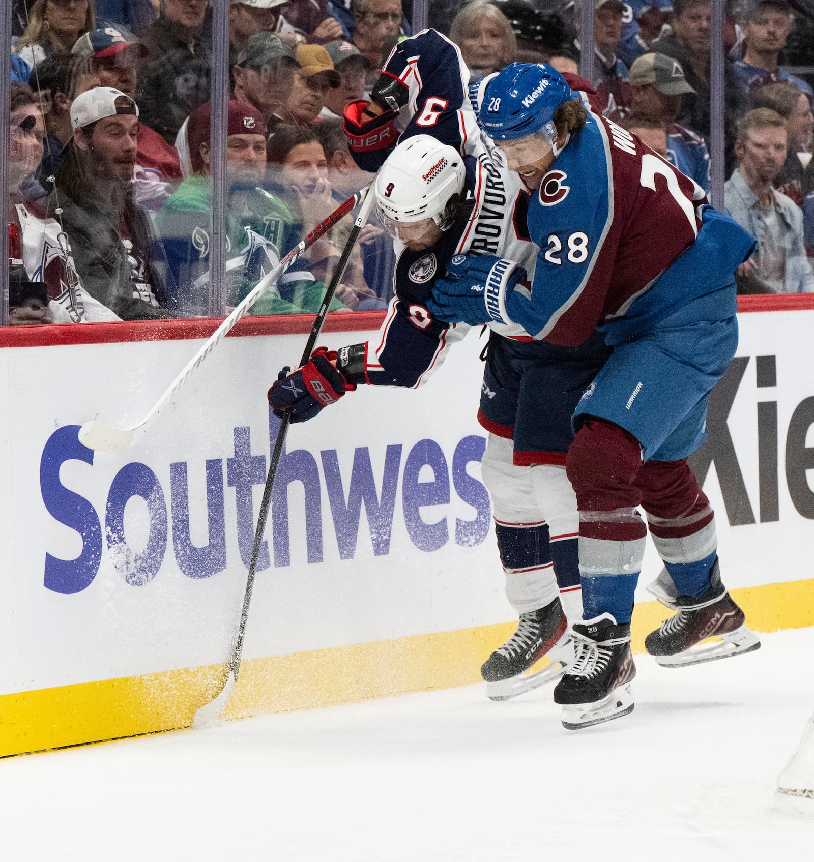 Colorado Avalanche left wing Miles Wood (28) battles Columbus Blue Jackets defenseman Ivan Provorov (9) for the puck during the first period of an NHL hockey game, Saturday, Oct. 12, 2024, at Ball Arena in Denver. (Christian Murdock/The Gazette via AP)