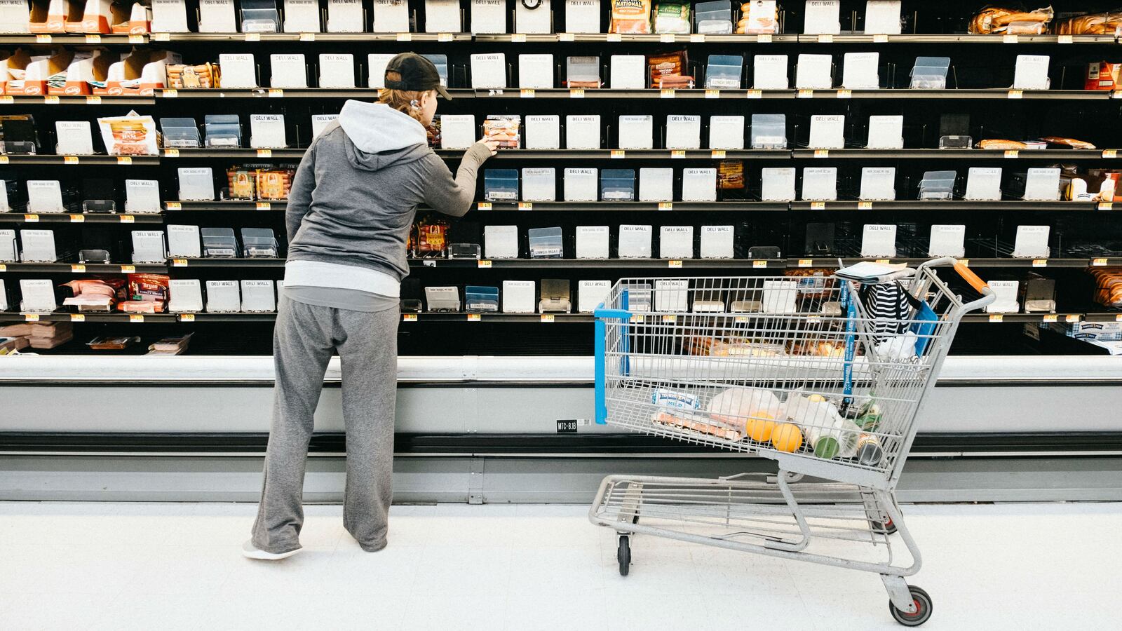 A woman shops from the nearly empty deli section of a Walmart Supercenter March 14, 2020, in Nashville. The World Health Organization in March declared COVID-19, the respiratory illness caused by the novel coronavirus, a global pandemic.