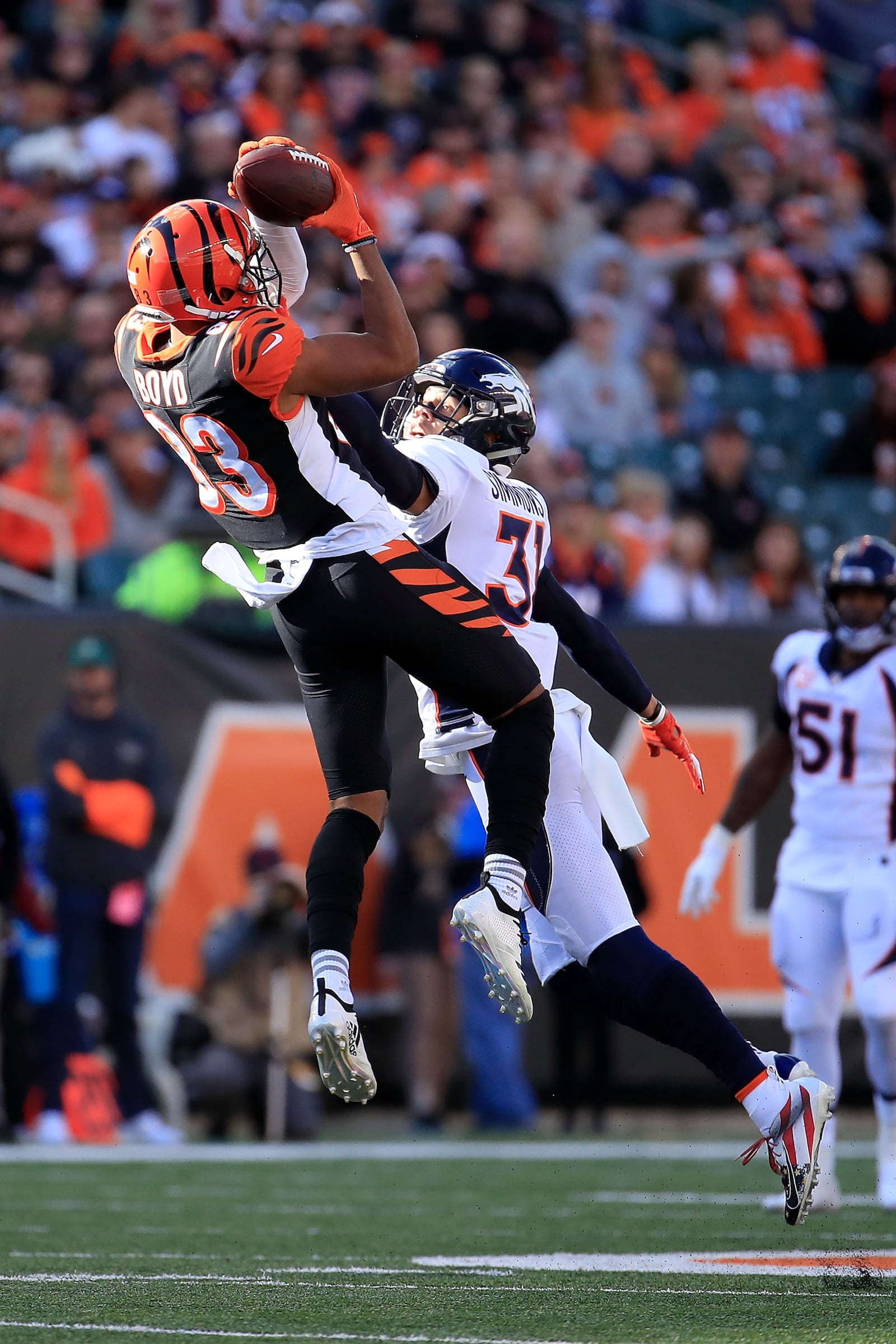 CINCINNATI, OH - DECEMBER 2:  Tyler Boyd #83 of the Cincinnati Bengals catches a pass while being defended by Justin Simmons #31 of the Denver Broncos during the second quarter at Paul Brown Stadium on December 2, 2018 in Cincinnati, Ohio. (Photo by Andy Lyons/Getty Images)