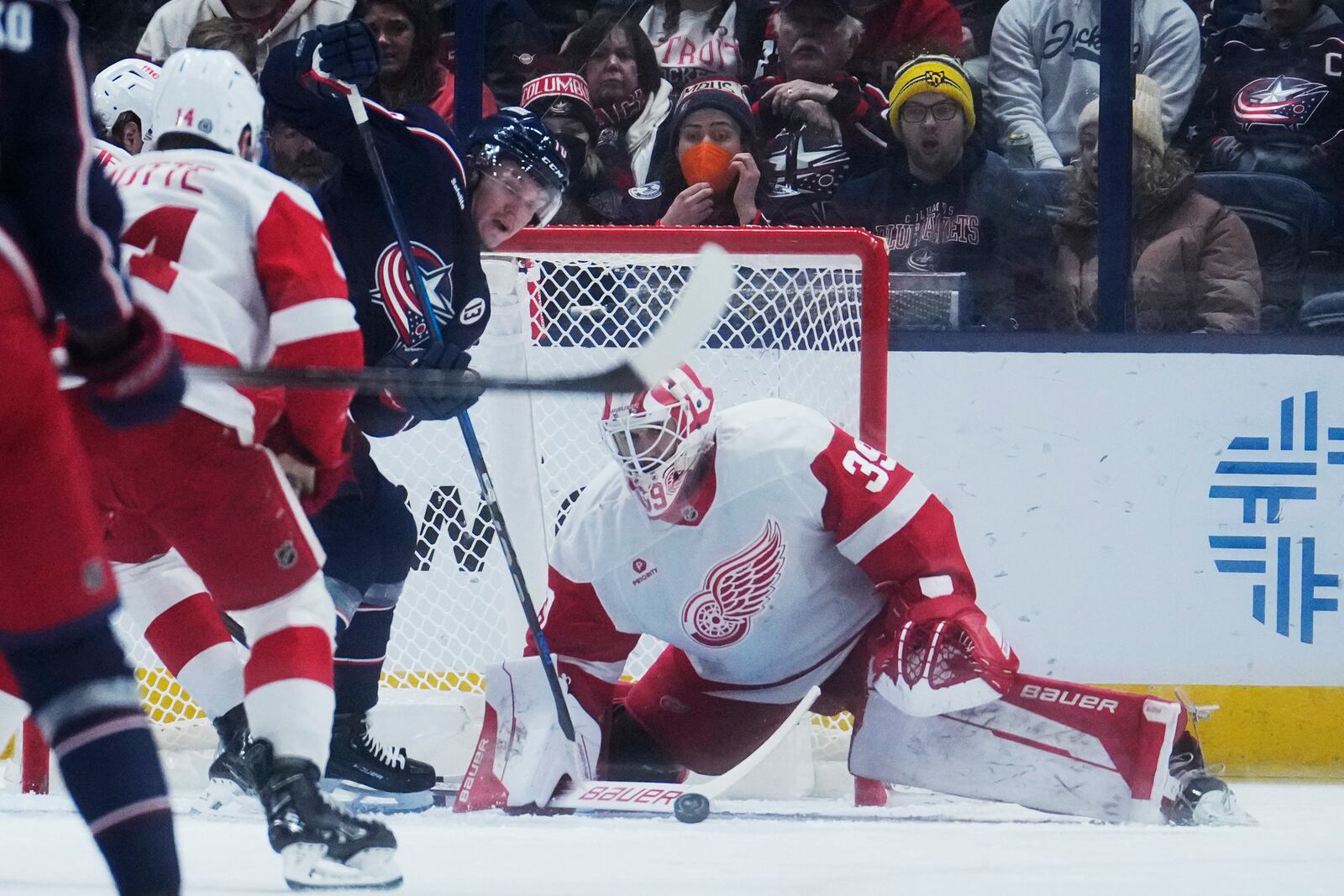 Detroit Red Wings goaltender Cam Talbot (39) blocks a shot by Columbus Blue Jackets left wing Dmitri Voronkov, left, in the first period of an NHL hockey game in Columbus, Ohio, Thursday, Jan. 2, 2025. (AP Photo/Sue Ogrocki)