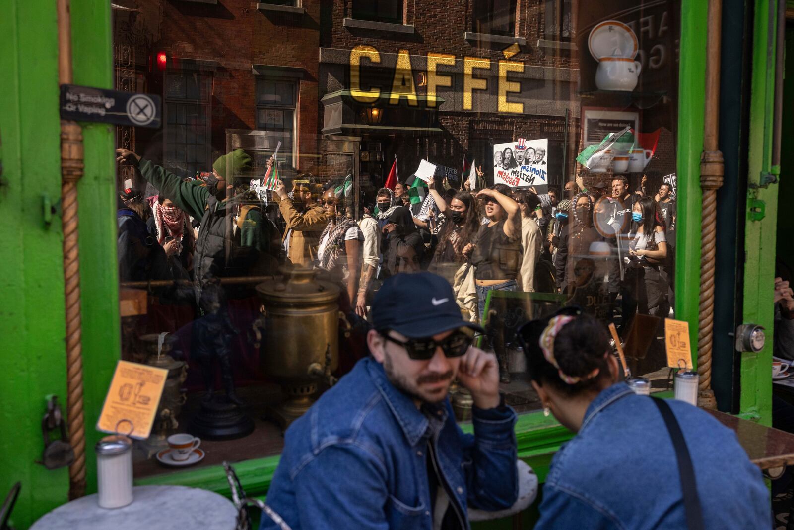 A reflection on the window shows protesters marching during a demonstration in support of Palestinian activist Mahmoud Khalil, Tuesday, March 11, 2025, in New York. (AP Photo/Yuki Iwamura)