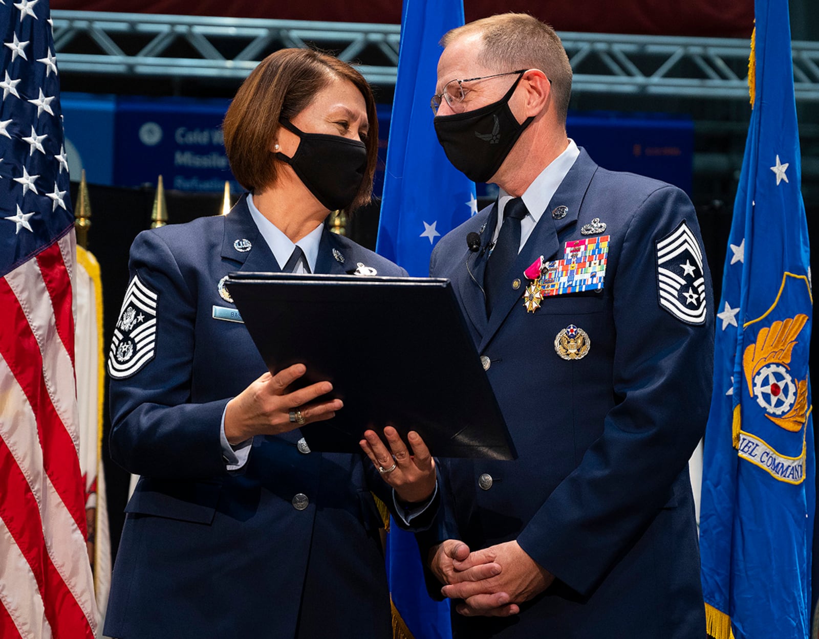 Chief Master Sgt. of the Air Force JoAnne Bass presents a letter of appreciation to Chief Master Sgt. Stanley Cadell, Air Force Materiel Command command chief, during his retirement ceremony Oct. 1 in the National Museum of the U.S. Air Force. Cadell retired after 30 years of service. U.S. AIR FORCE PHOTO/R.J. ORIEZ