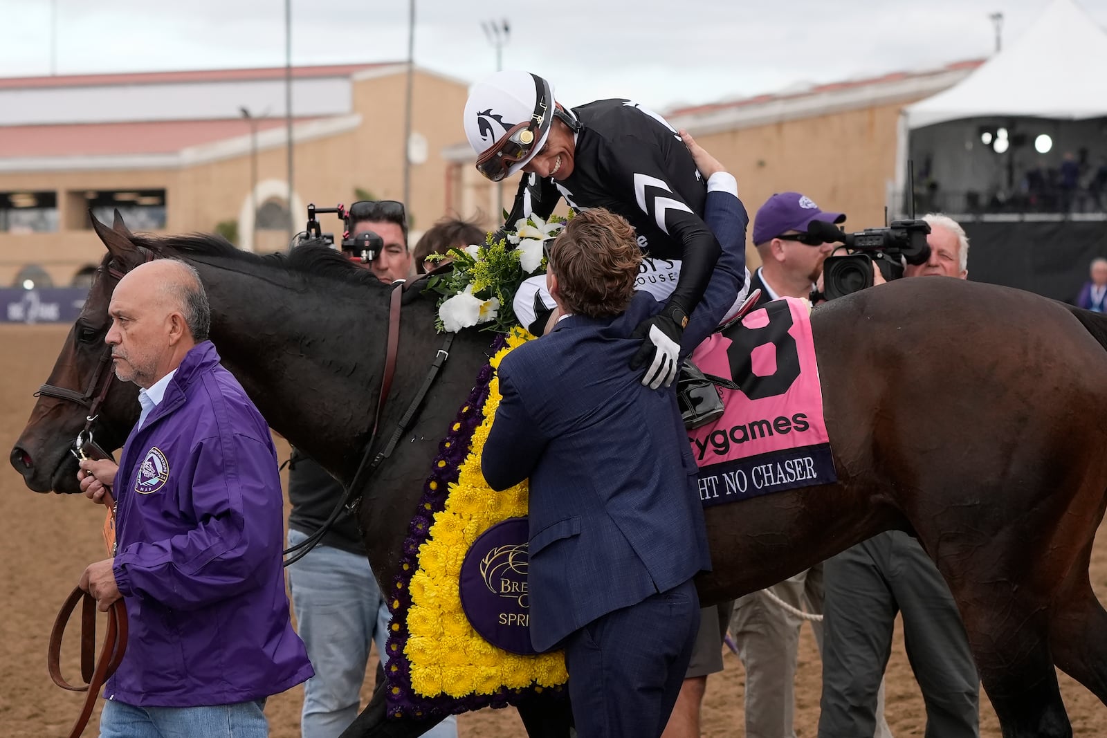 John Velazquez, top, celebrates with Dan Blacker after riding Straight No Chaser to victory in the Breeders' Cup Sprint horse race in Del Mar, Calif., Saturday, Nov. 2, 2024. (AP Photo/Gregory Bull)