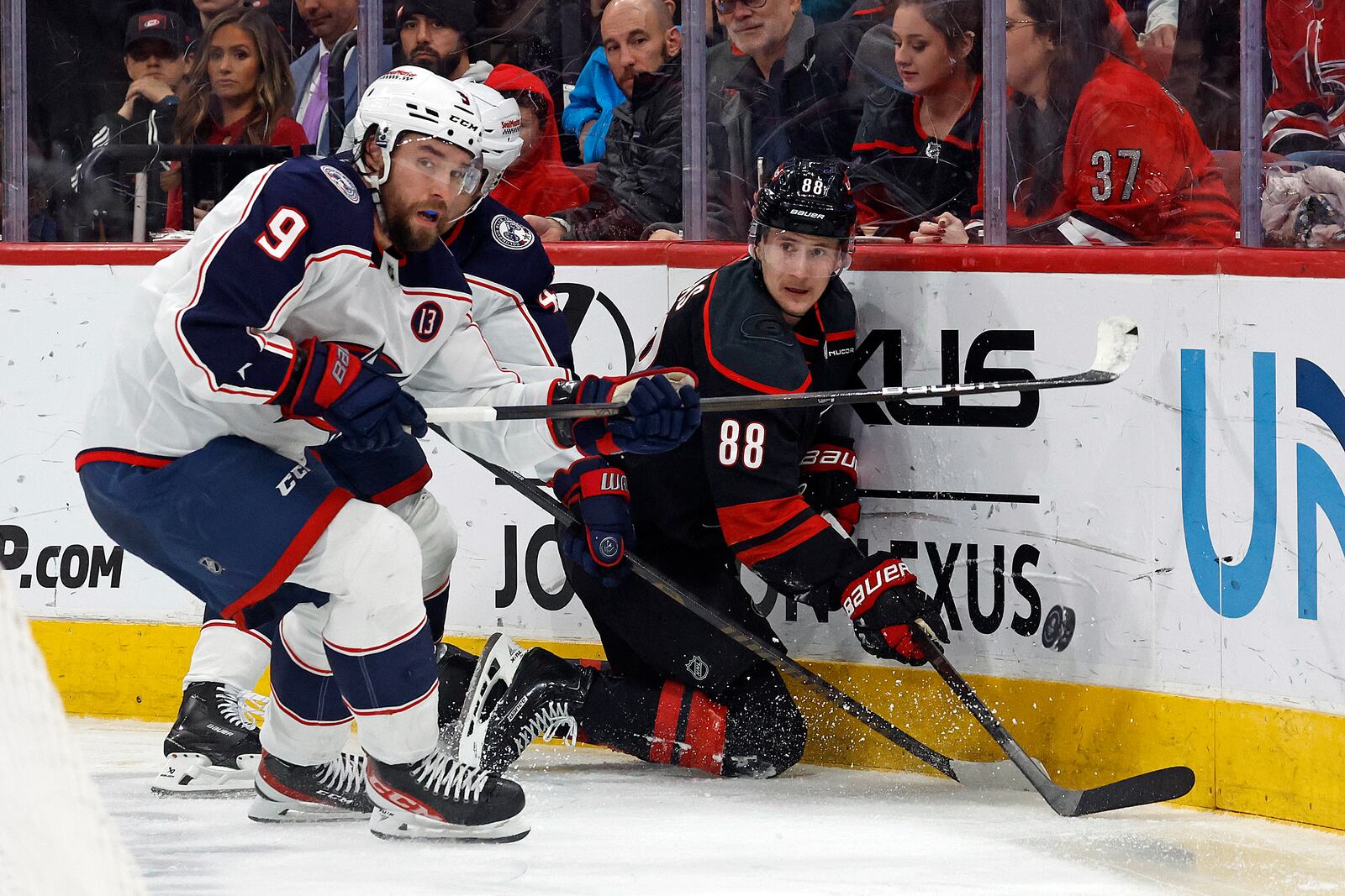 Carolina Hurricanes' Martin Necas (88) clears the puck away from Columbus Blue Jackets' Ivan Provorov (9) during the second period of an NHL hockey game in Raleigh, N.C., Sunday, Dec. 15, 2024. (AP Photo/Karl B DeBlaker)