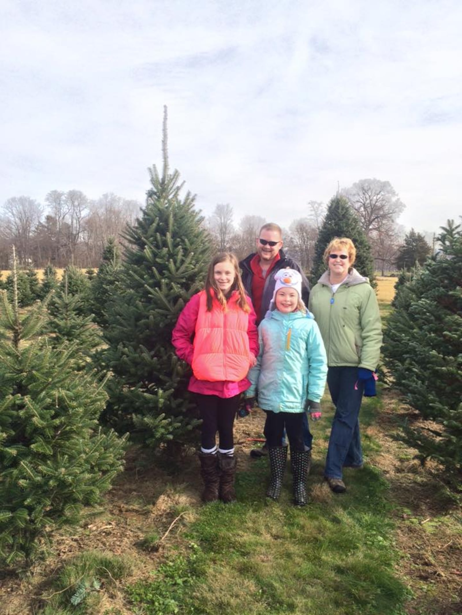 Cutting down the family Christmas tree has been a holiday tradition for the Schneider family, of Kettering, for more than 30 years. CONTRIBUTED