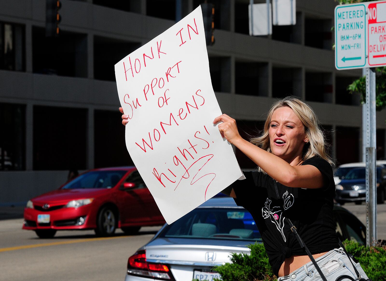 Lily Steiner holds up her sign Monday, June 24, 2024 at the Federal Building in Dayton while protesting anti-abortion efforts across the country and the Supreme Court's Dobbs decision from two years ago. MARSHALL GORBY\STAFF