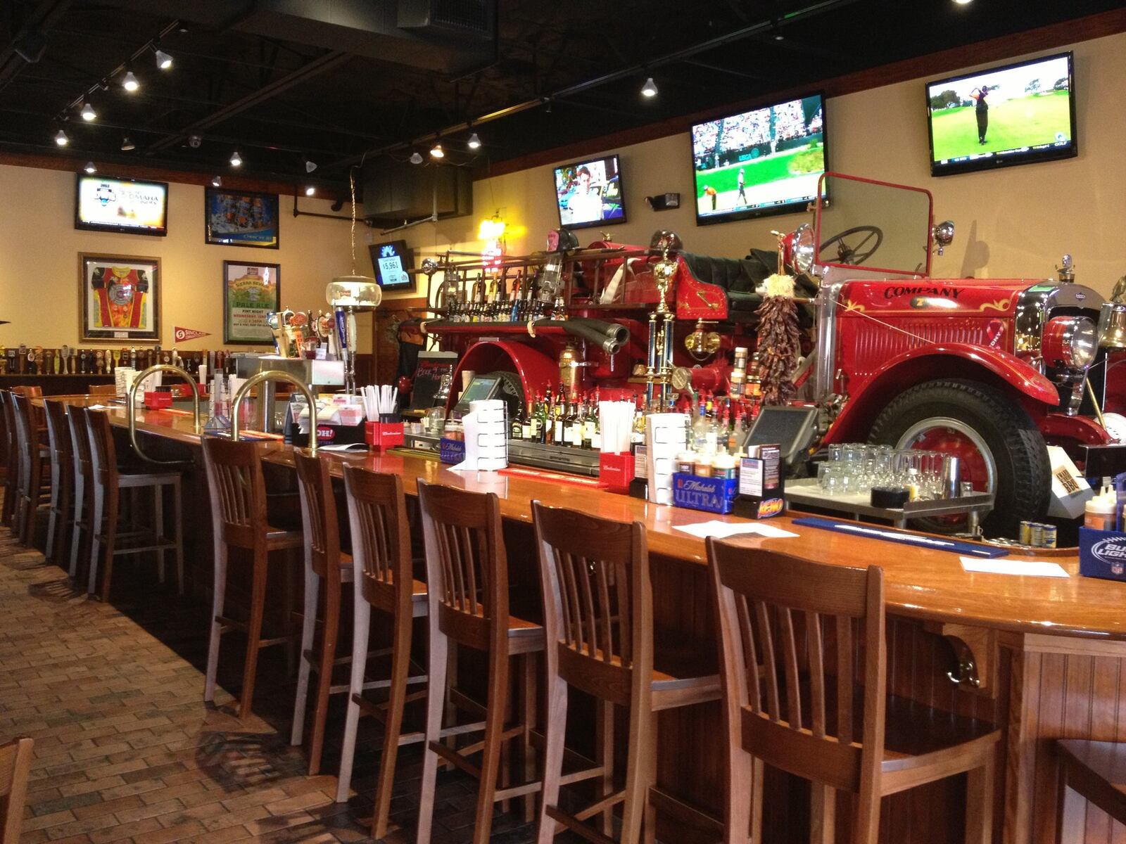 The impressive bar at Company 7 BBQ in Englewood features an antique fire truck. Contributed photo by Alexis Larsen