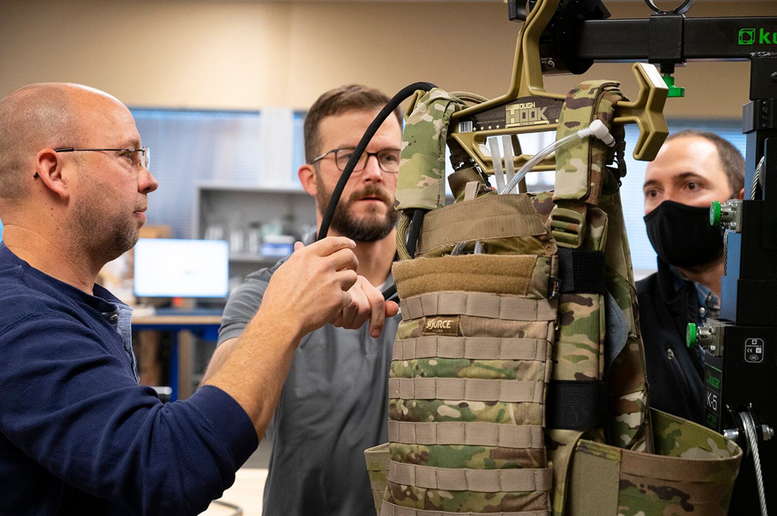 Matthew Sunday (left) and Joe Althaus (center), Wright Brothers Institute Rapid Innovation Program engineers, and Mike Moulton, an Air Force Research Laboratory engineer, work on the liquid-cooled plate carrier prototype in a lab Dec. 1. The institute and AFRL collaborated to build the prototype for testing. U.S. AIR FORCE PHOTO/R.J. ORIEZv