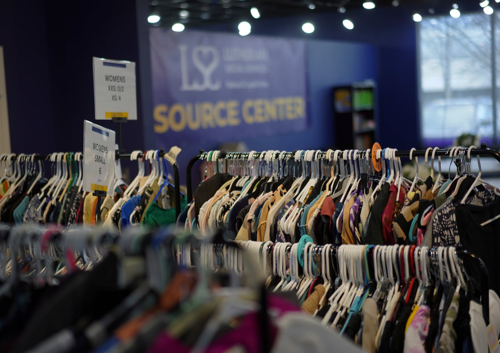 Donated clothes are organized and hung at the Lutheran Social Services National Capital Area Resource Center in Alexandria, Va., Thursday, March 6, 2025. (AP Photo/Jessie Wardarski)