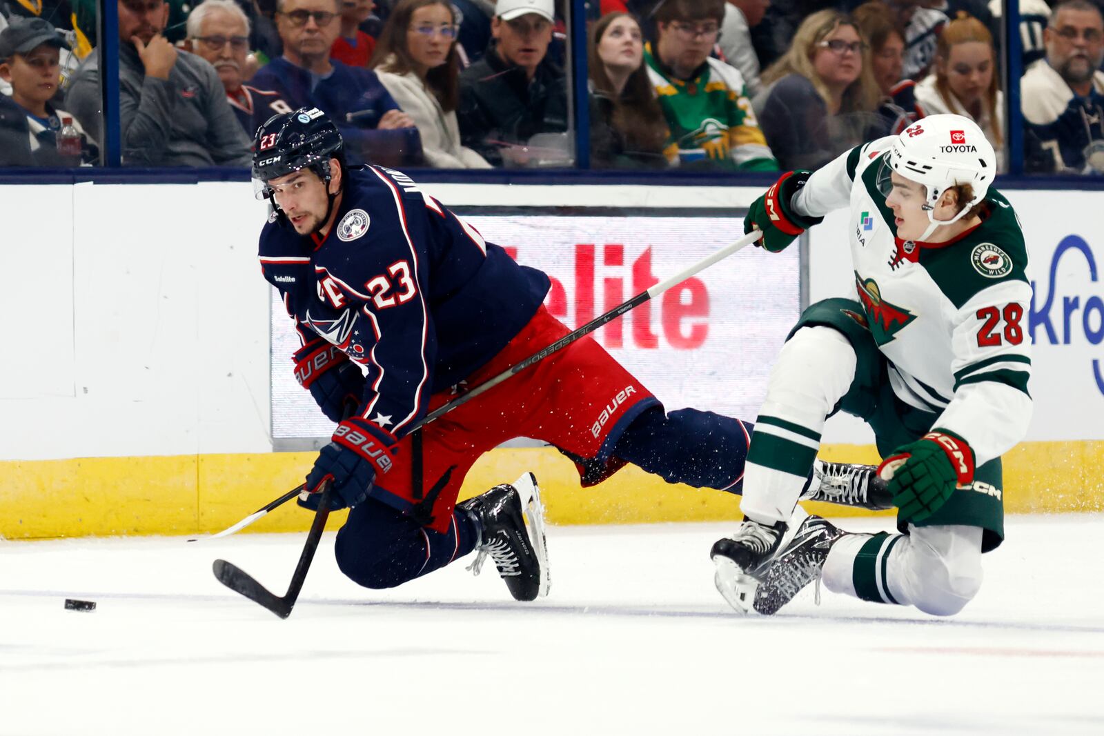 Columbus Blue Jackets defenseman Sean Monahan, left, collides with Minnesota Wild forward Liam Ohgren during the second period of an NHL hockey game in Columbus, Ohio, Saturday, Oct. 19, 2024. (AP Photo/Paul Vernon)