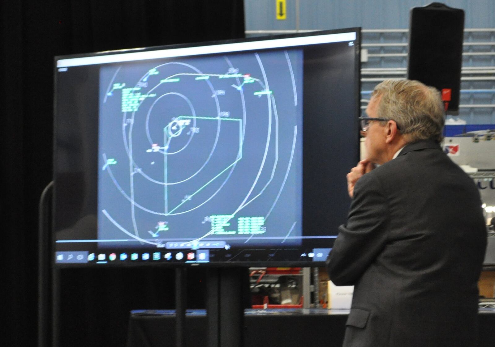 Ohio Gov. Mike DeWine looks at an image from an air traffic control module in SkyVision. The new technology will allow pilots to fly drones out of the line of sight at the Springfield airport.