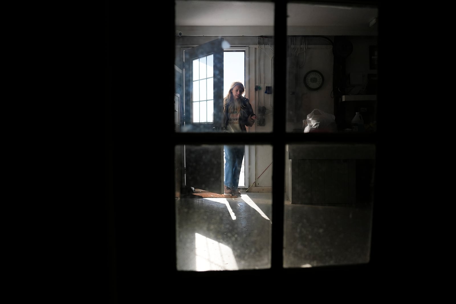 Zoe Kent walks into a machine shed, Monday, Jan. 20, 2025, at her farm in Bucyrus, Ohio. (AP Photo/Joshua A. Bickel)