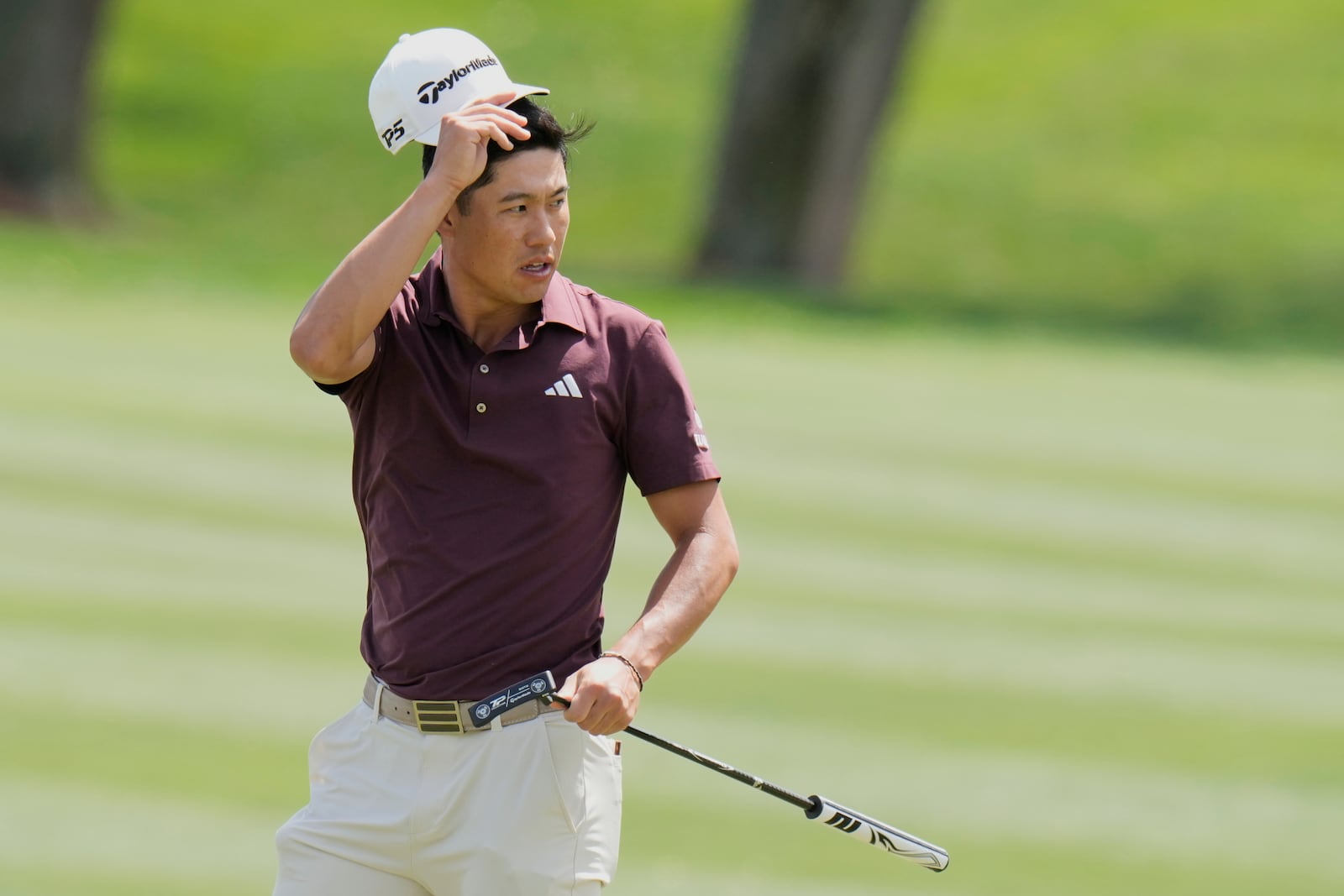 Collin Morikawa removes his cap after making a birdie on the ninth hole during the second round of The Players Championship golf tournament Friday, March 14, 2025, in Ponte Vedra Beach, Fla. (AP Photo/Chris O'Meara)