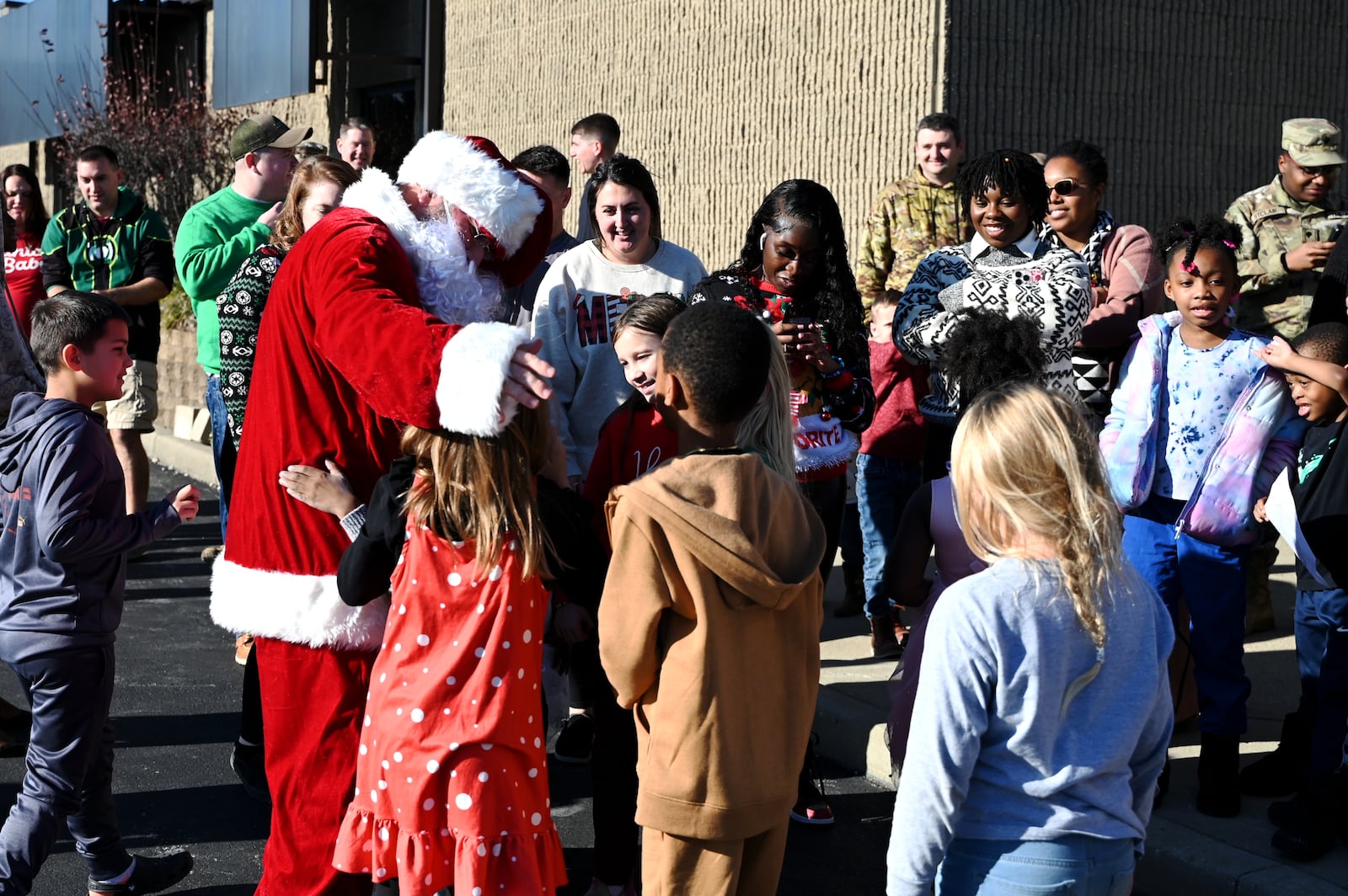 Santa Claus greets children of members of the 237th BSB Delta Company and HHT 2nd 107th Calvary Squadron at the Maj. Gen. Charles H. Jones National Guard Armory in Hamilton on Sunday, Dec. 8, 2024. MICHAEL D. PITMAN/STAFF