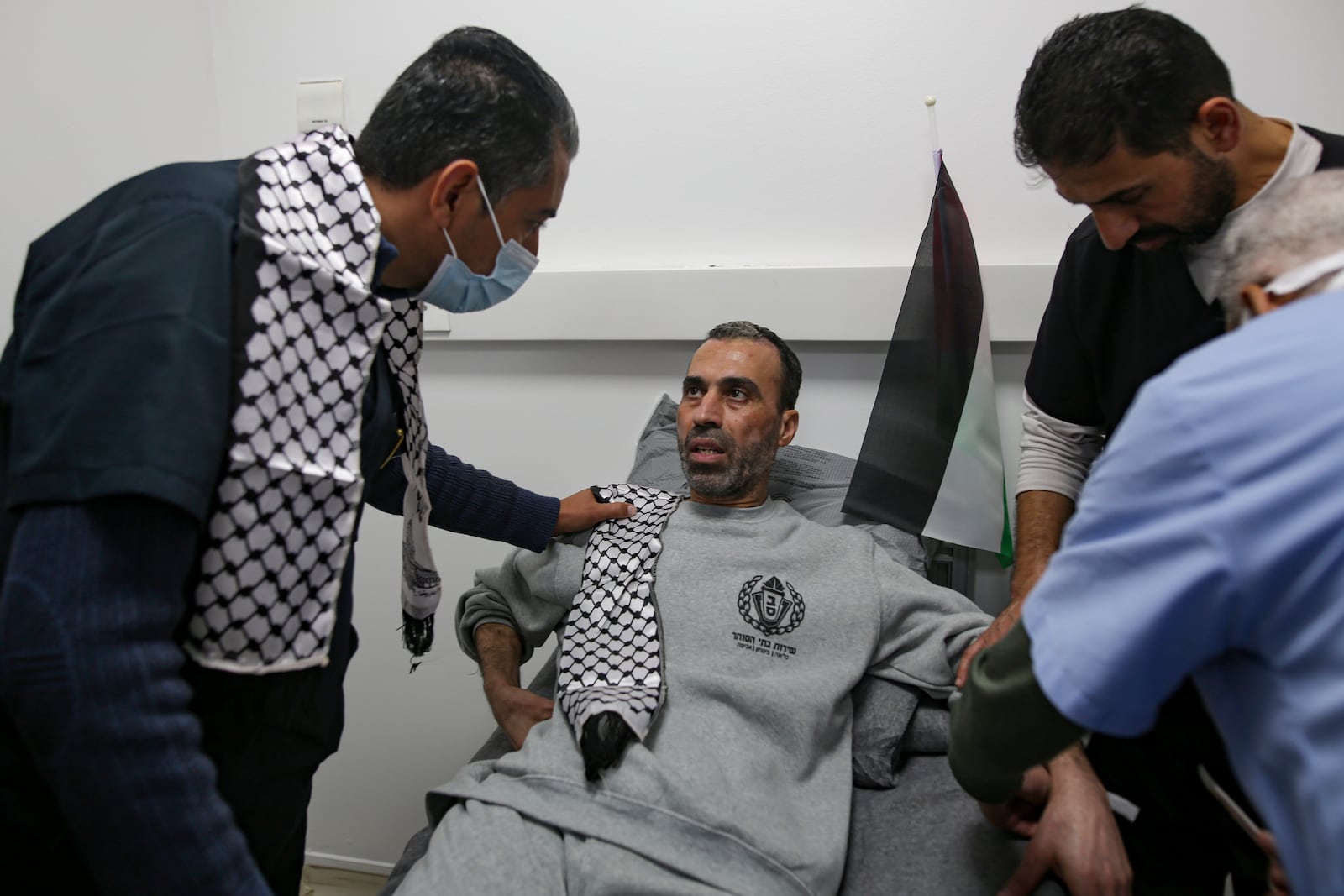 A freed Palestinian prisoner sits at a medical center as he arrives in the Gaza Strip after being released from an Israeli prison following a ceasefire agreement between Hamas and Israel in Khan Younis, Thursday, Jan. 30, 2025. (AP Photo/Jehad Alshrafi)