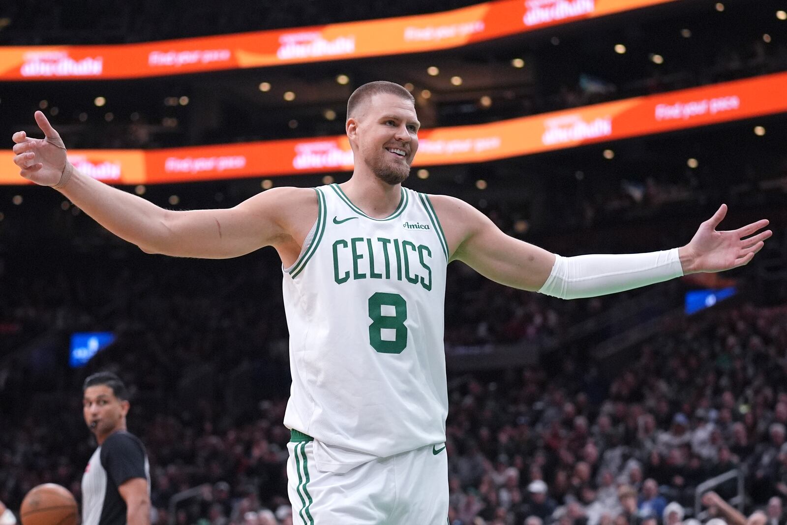 Boston Celtics center Kristaps Porzingis smiles at the crowd after drawing a technical foul during the first half of an NBA basketball game against the Houston Rockets, Monday, Jan. 27, 2025, in Boston. (AP Photo/Charles Krupa)