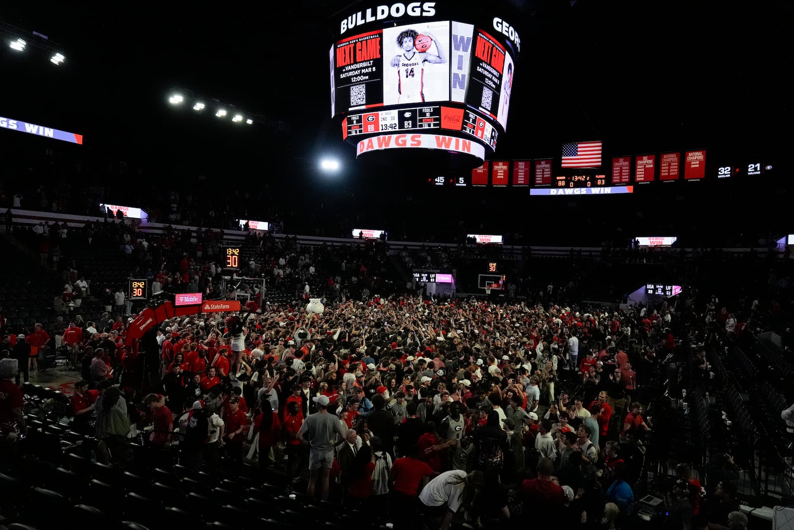 Georgia fans rush the court in celebration after an NCAA college basketball game against Florida, Tuesday, Feb. 25, 2025, in Athens, Ga. (AP Photo/Brynn Anderson)