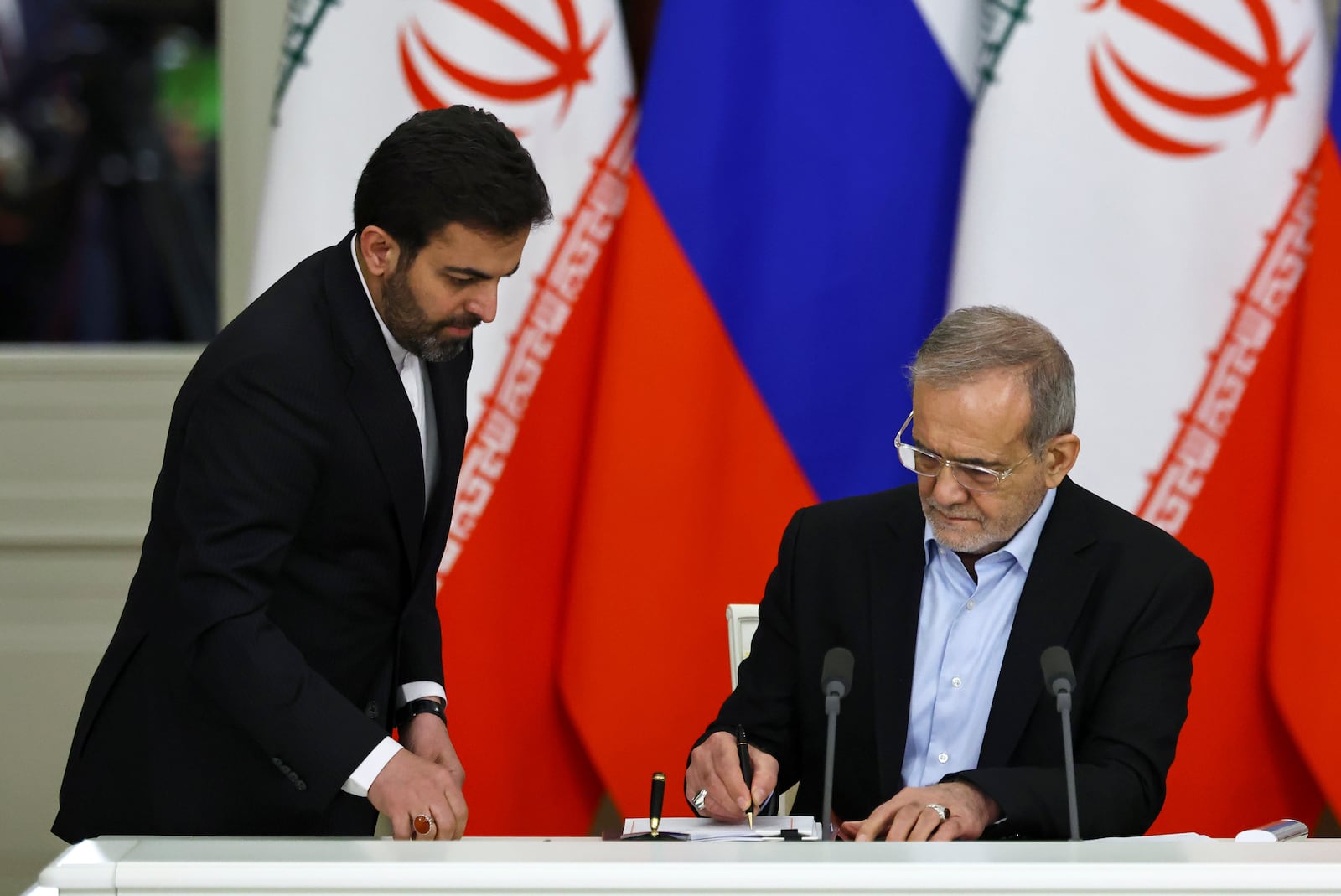 Iranian President Masoud Pezeshkian, right, attends a signing ceremony with Russian President Vladimir Putin at the Kremlin in Moscow, Russia, Friday, Jan. 17, 2025. (Evgenia Novozhenina/Pool Photo via AP)