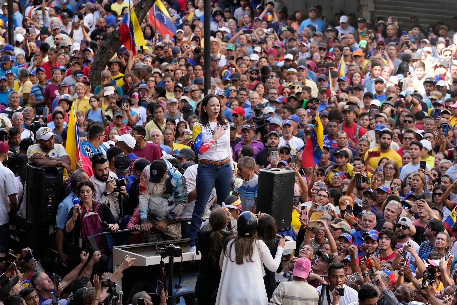 Opposition leader Maria Corina Machado stands before supporters during a protest against President Nicolas Maduro the day before his inauguration for a third term, in Caracas, Venezuela, Thursday, Jan. 9, 2025. (AP Photo/Ariana Cubillos)