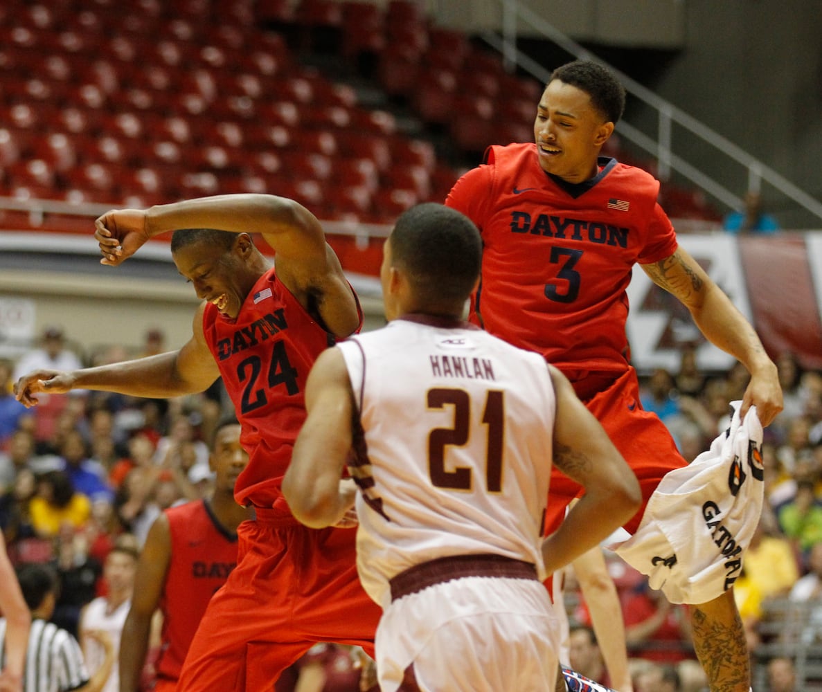 Dayton guards Jordan Sibert, left, and Kyle Davis, right, celebrate a basket in front of Boston College's Olivier Hanlan in the Puerto Rico Tip-Off on Sunday, Nov. 23, 2014, at Coliseo Roberto Clemente in San Juan, P.R. David Jablonski/Staff