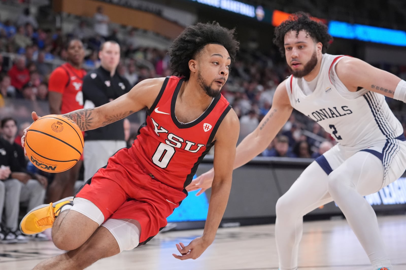 Youngstown State guard Jason Nelson (0) drives on Robert Morris guard Ryan Prather Jr. (2) in the second half of an NCAA college basketball game in the championship of the Horizon League tournament in Indianapolis, Tuesday, March 11, 2025. (AP Photo/Michael Conroy)